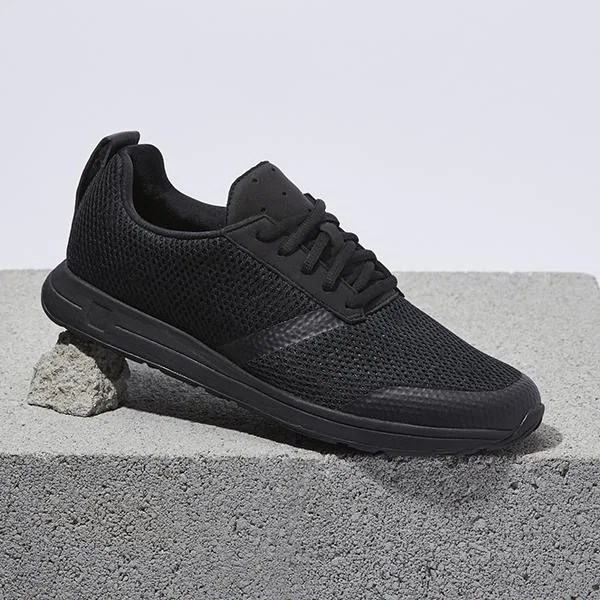 a black sneaker on a concrete block