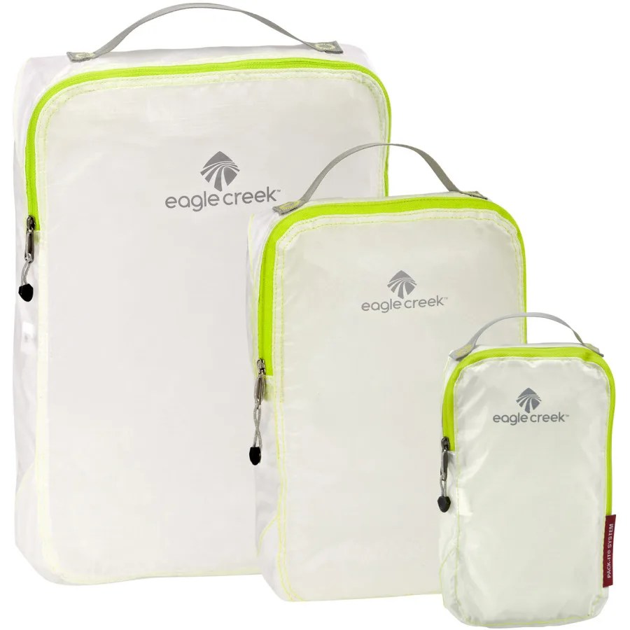 Three white packing cubes on a white background.