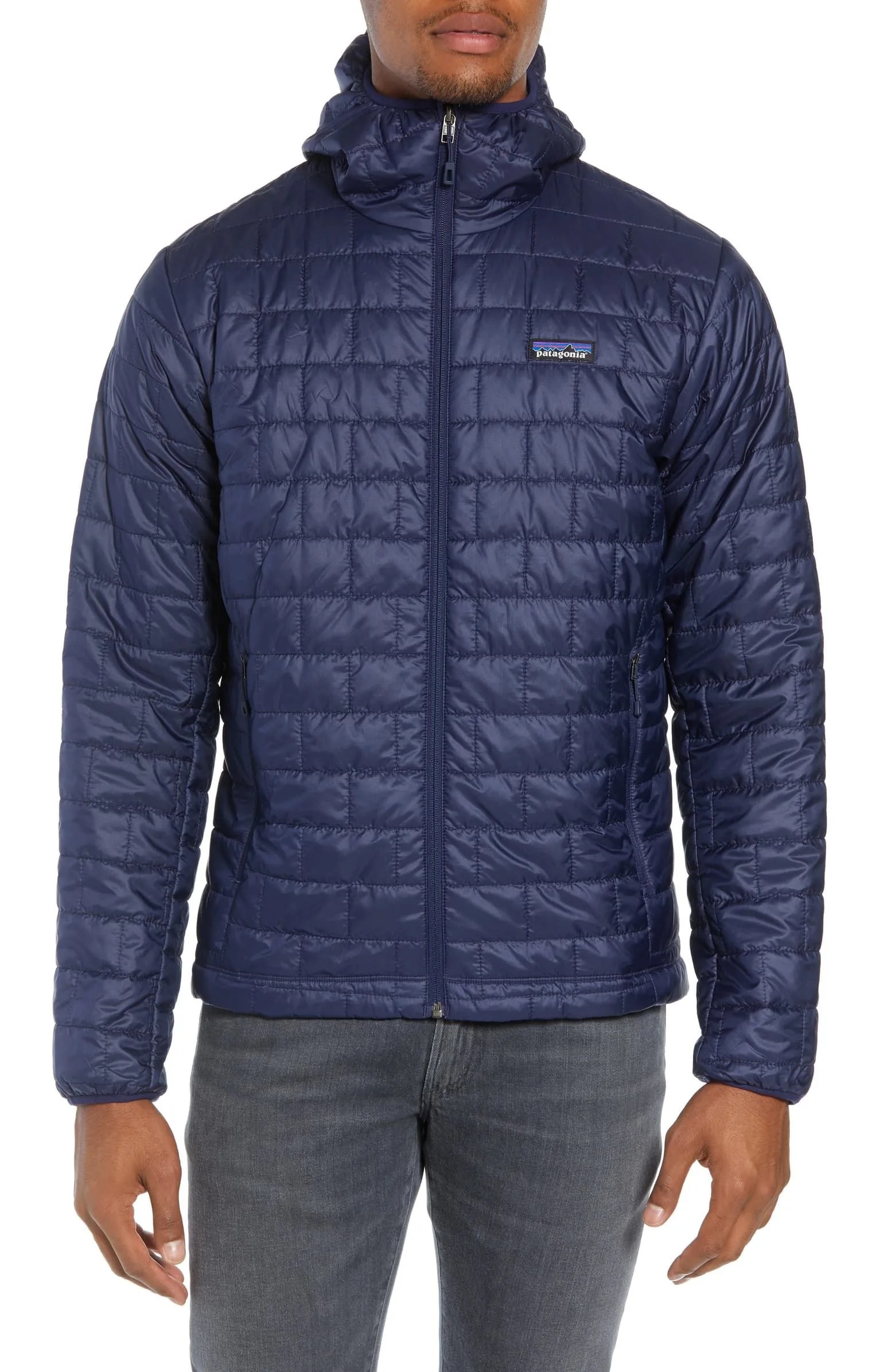 A model wearing a blue insulated hooded jacket on a white background.