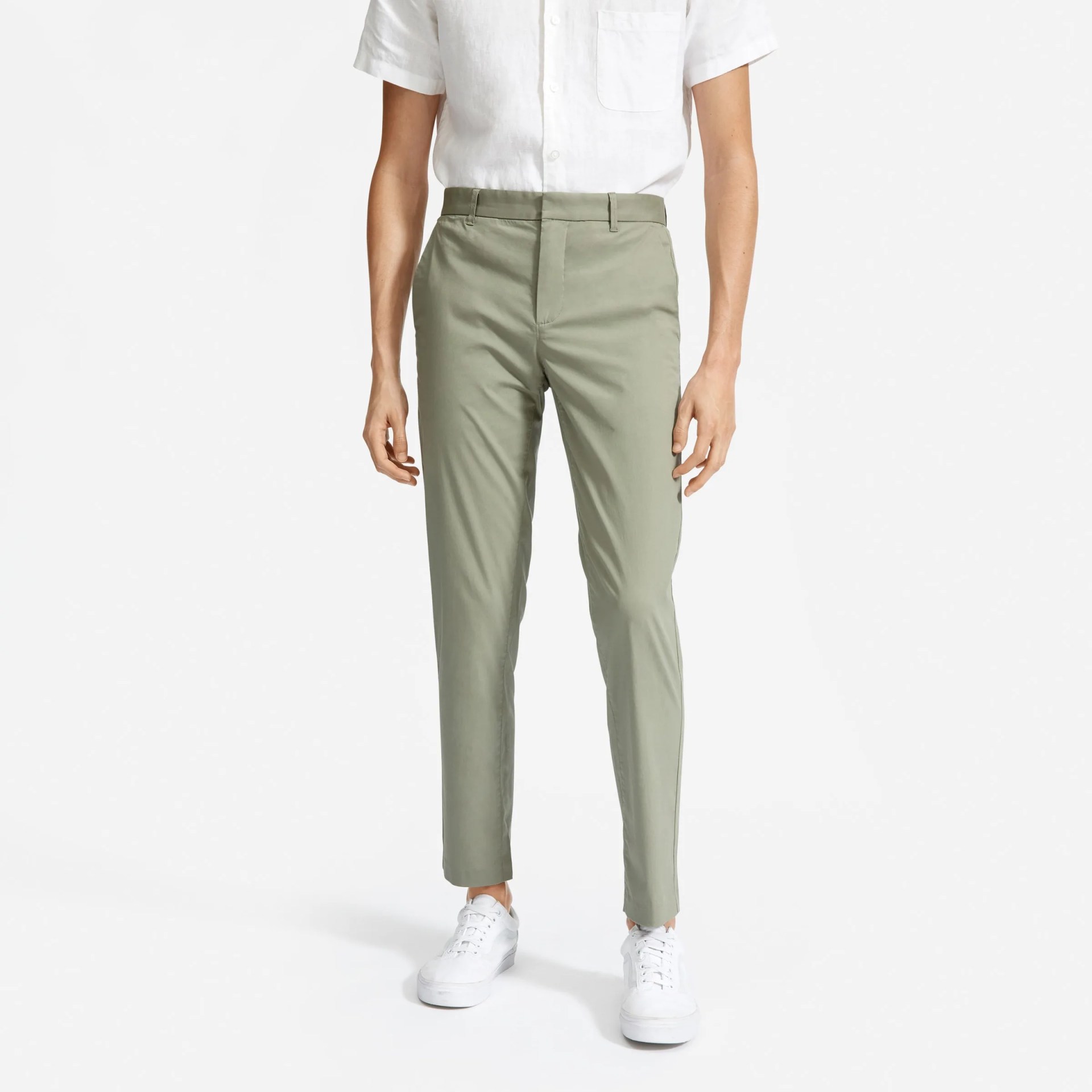 A model wearing sage chinos on a gray background.