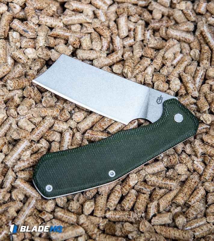 A folding knife on a pile of pellets.