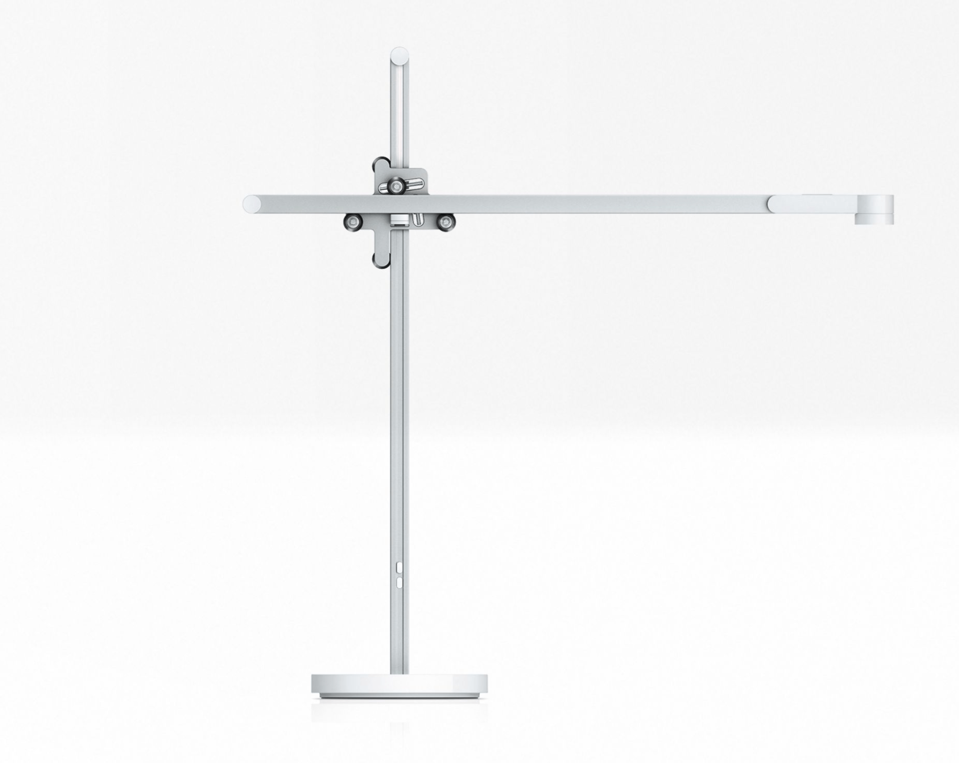 A silver and white desk light on a gray background.