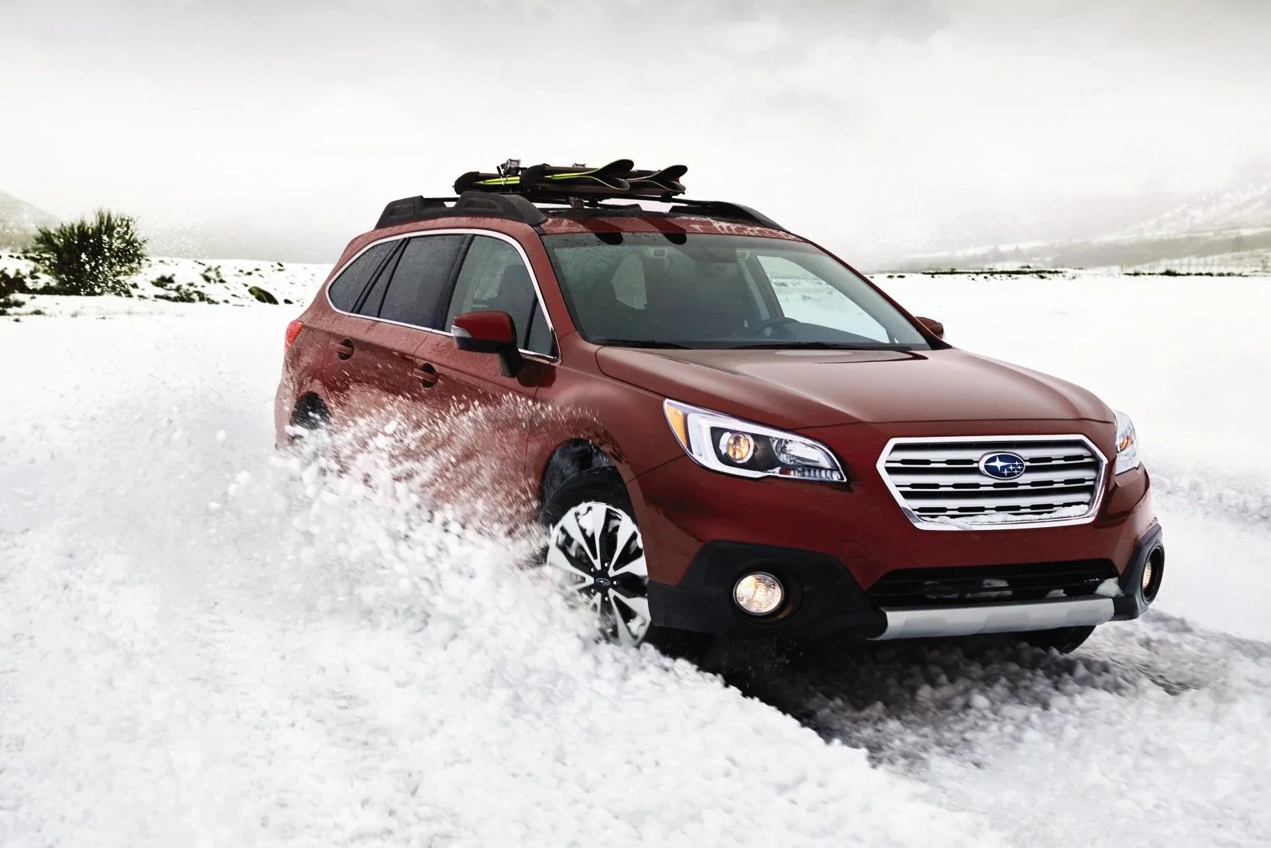 subaru outback driving through snow