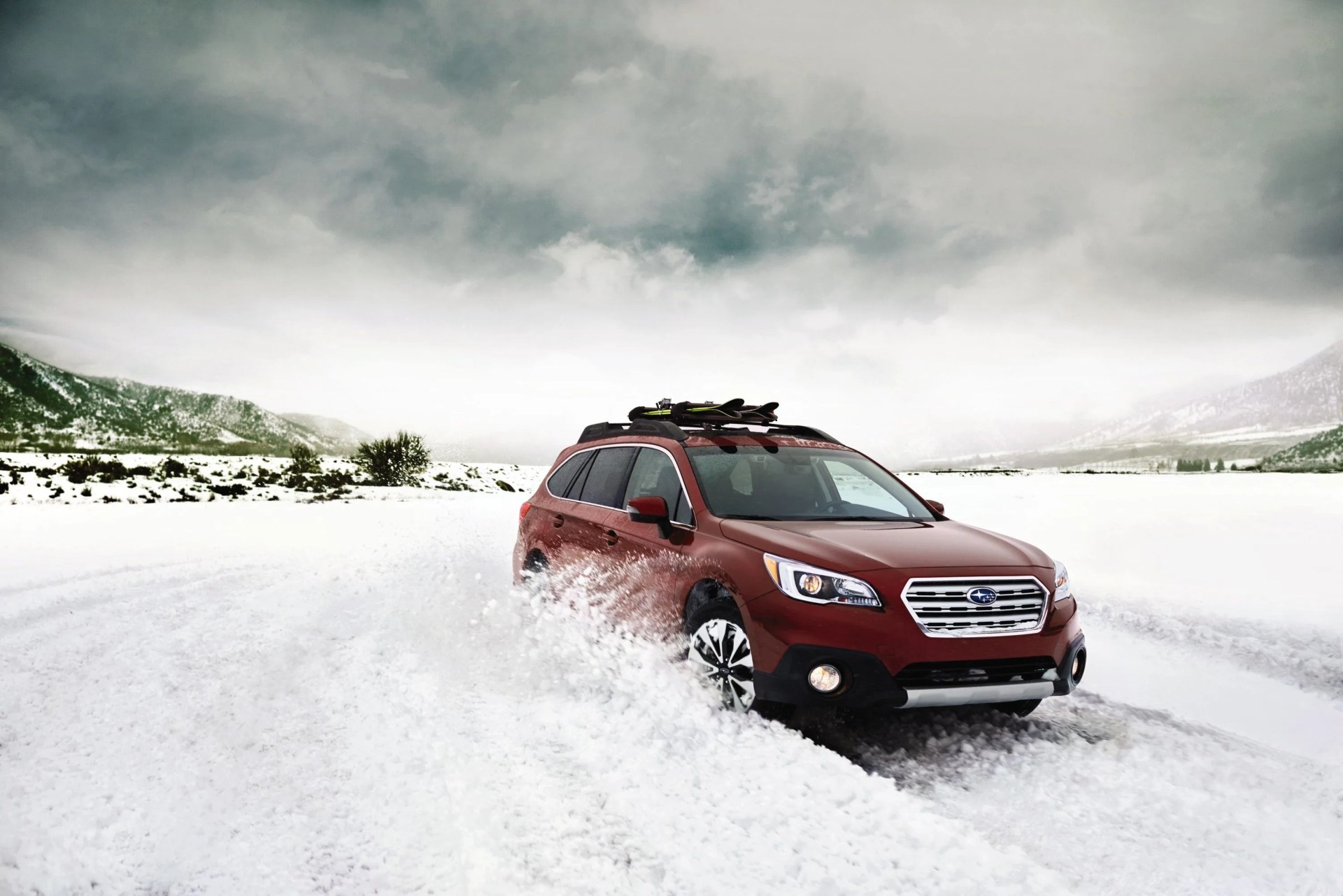 subaru outback driving through snow