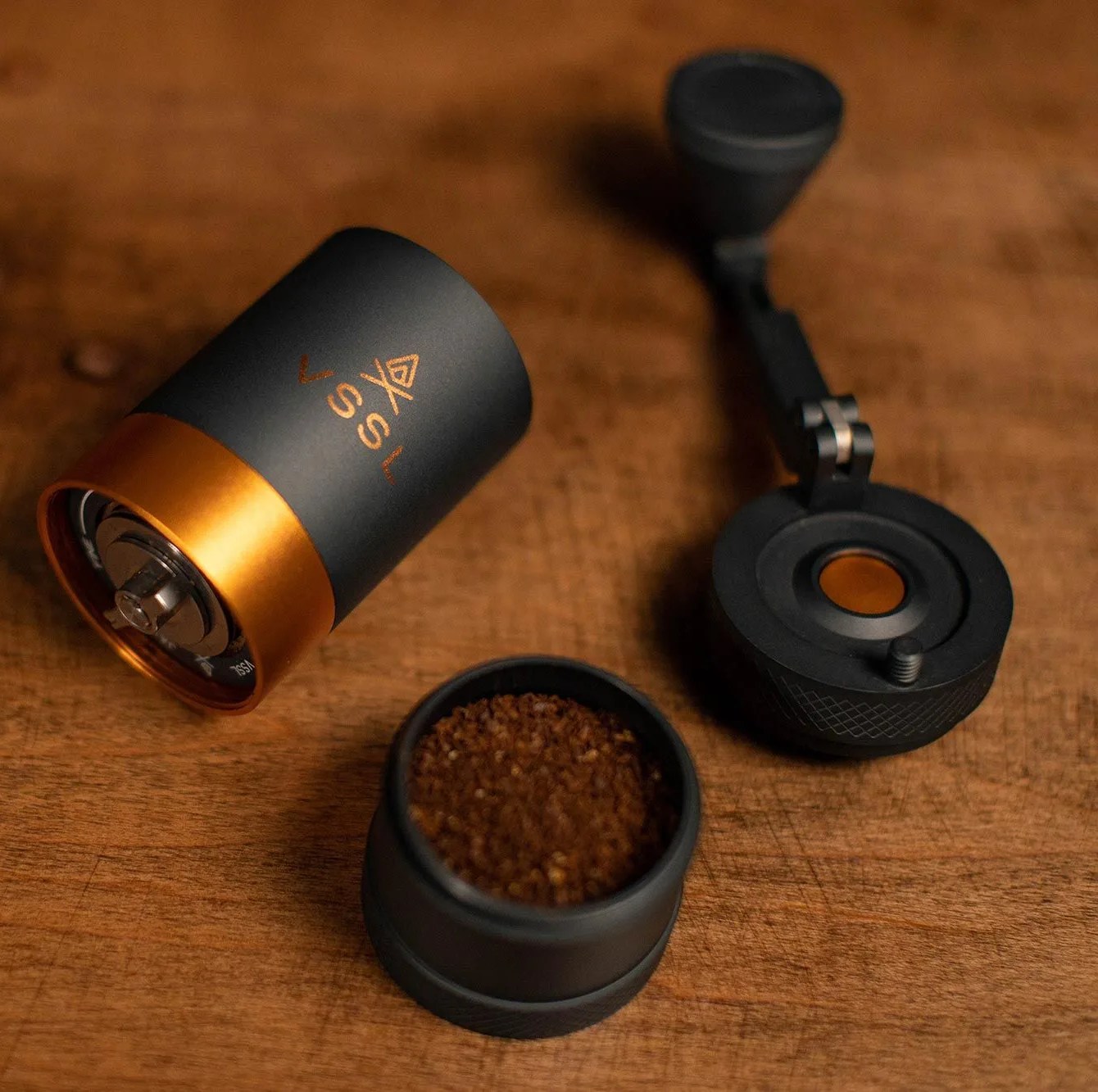deconstructed hand coffee grinder on wood