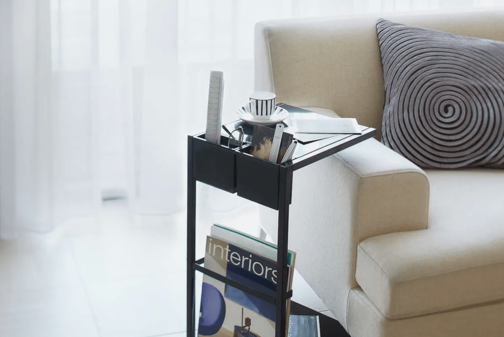 a living room set with a rolling side table and a couch
