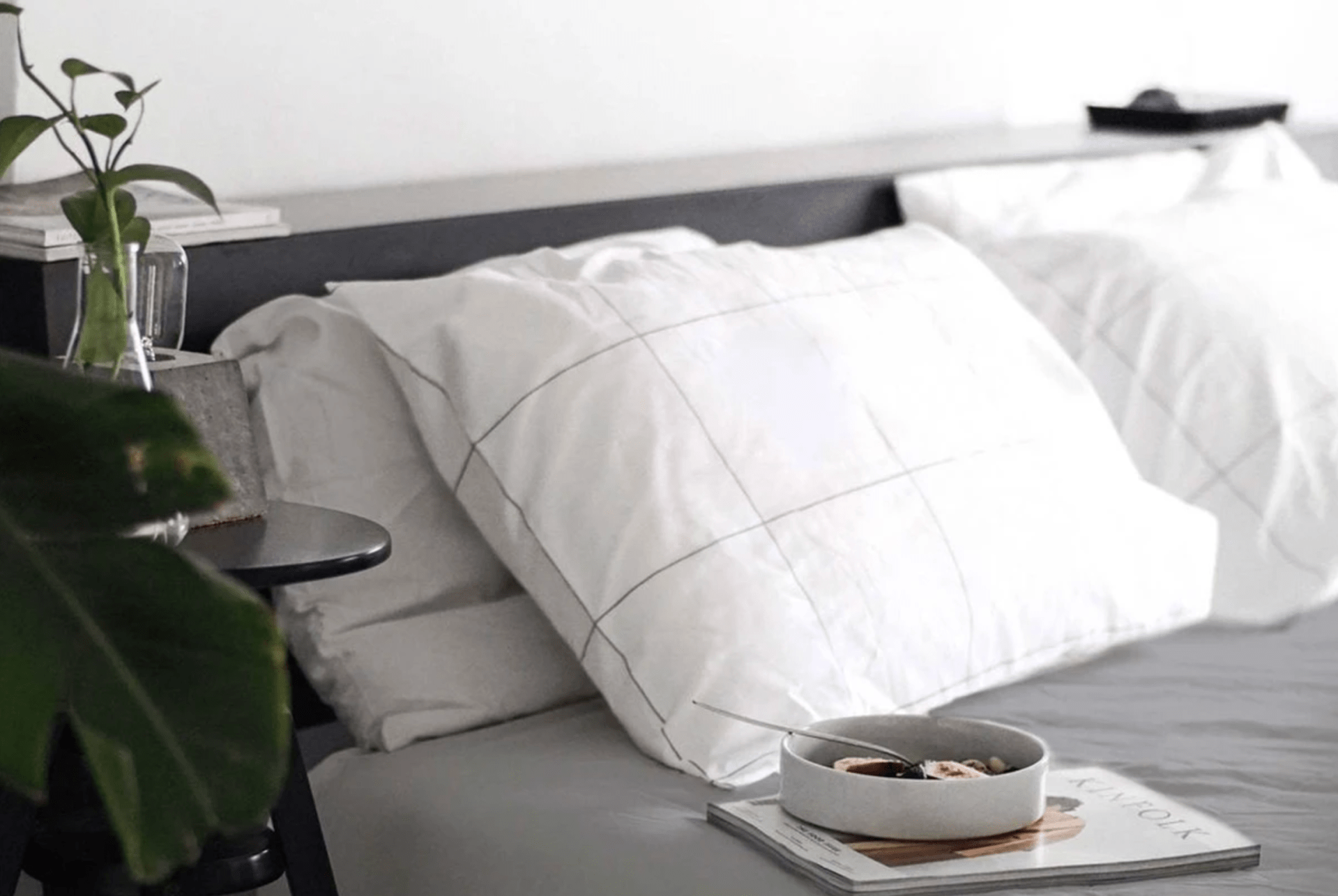 a bed with a gray duvet cover