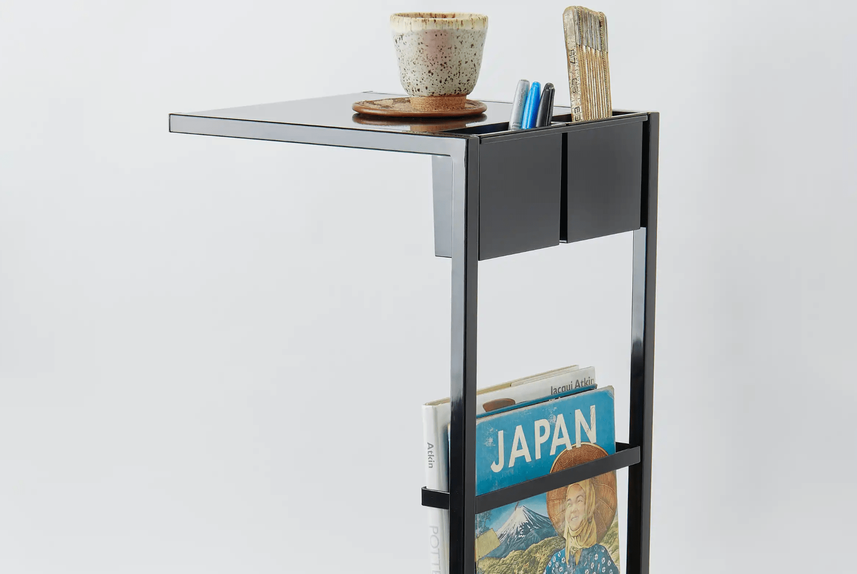 a side table on wheels on a gray background