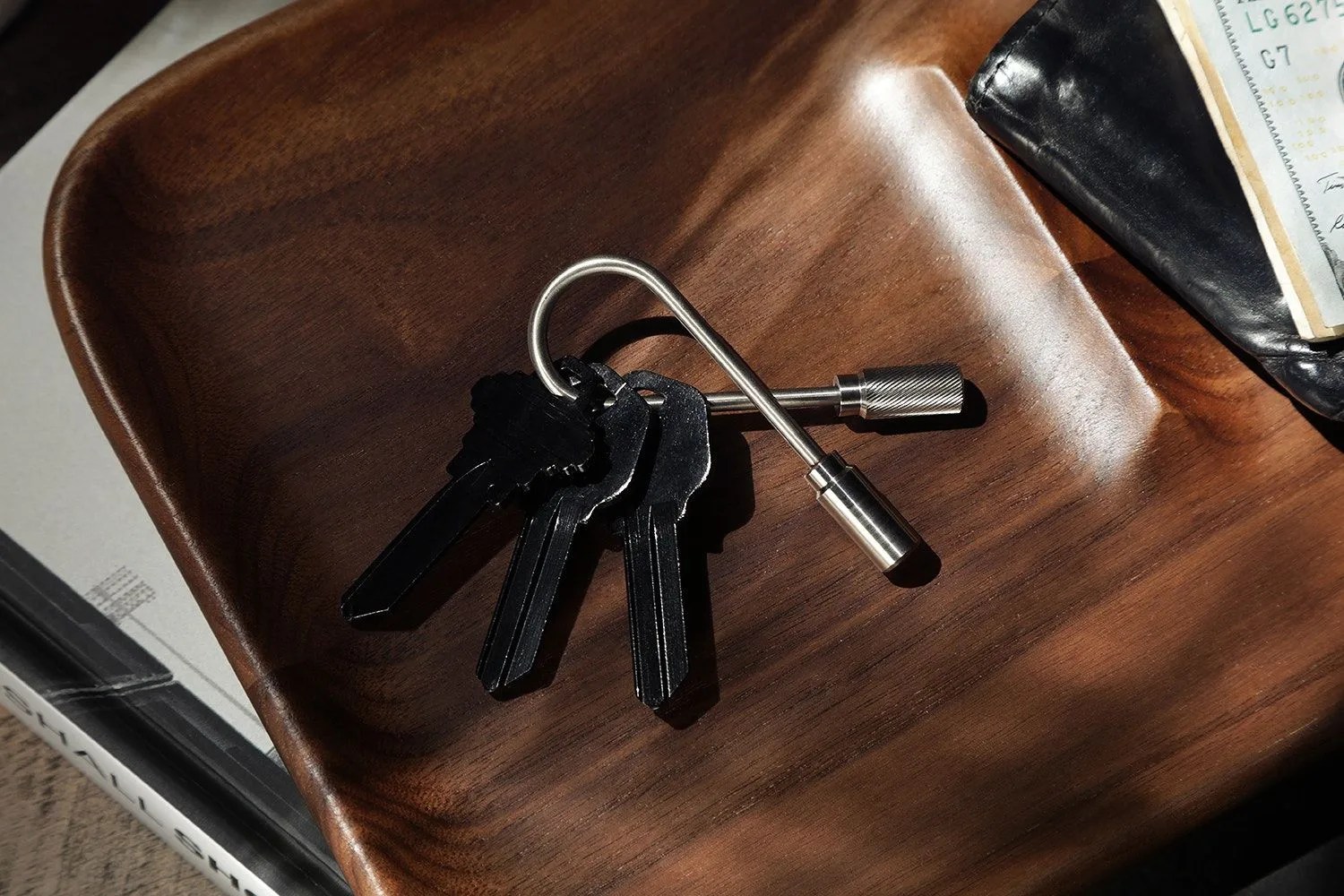 black keys and silver key ring in wood valet