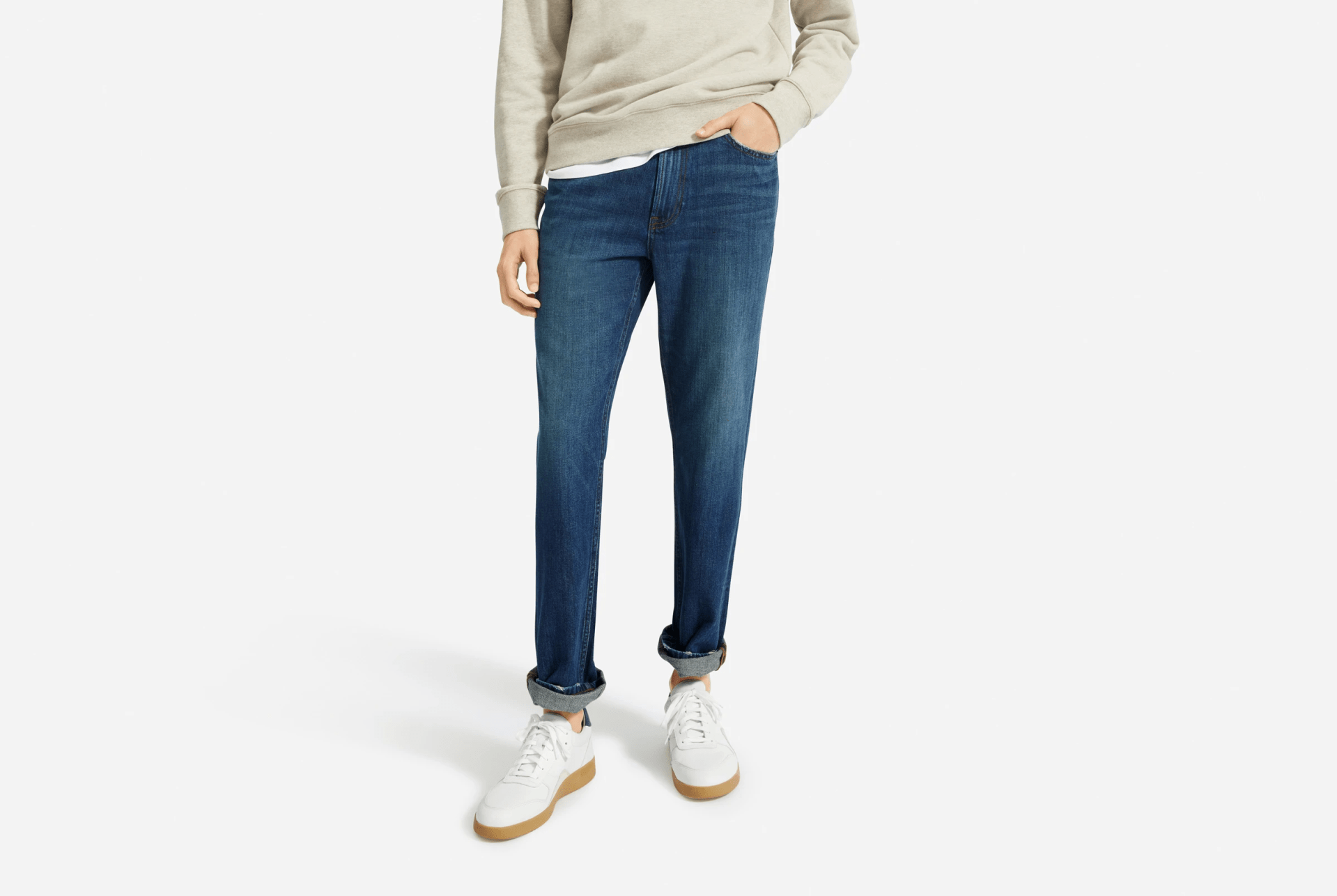 model wearing white sneakers, blue jeans and tan sweatshirt