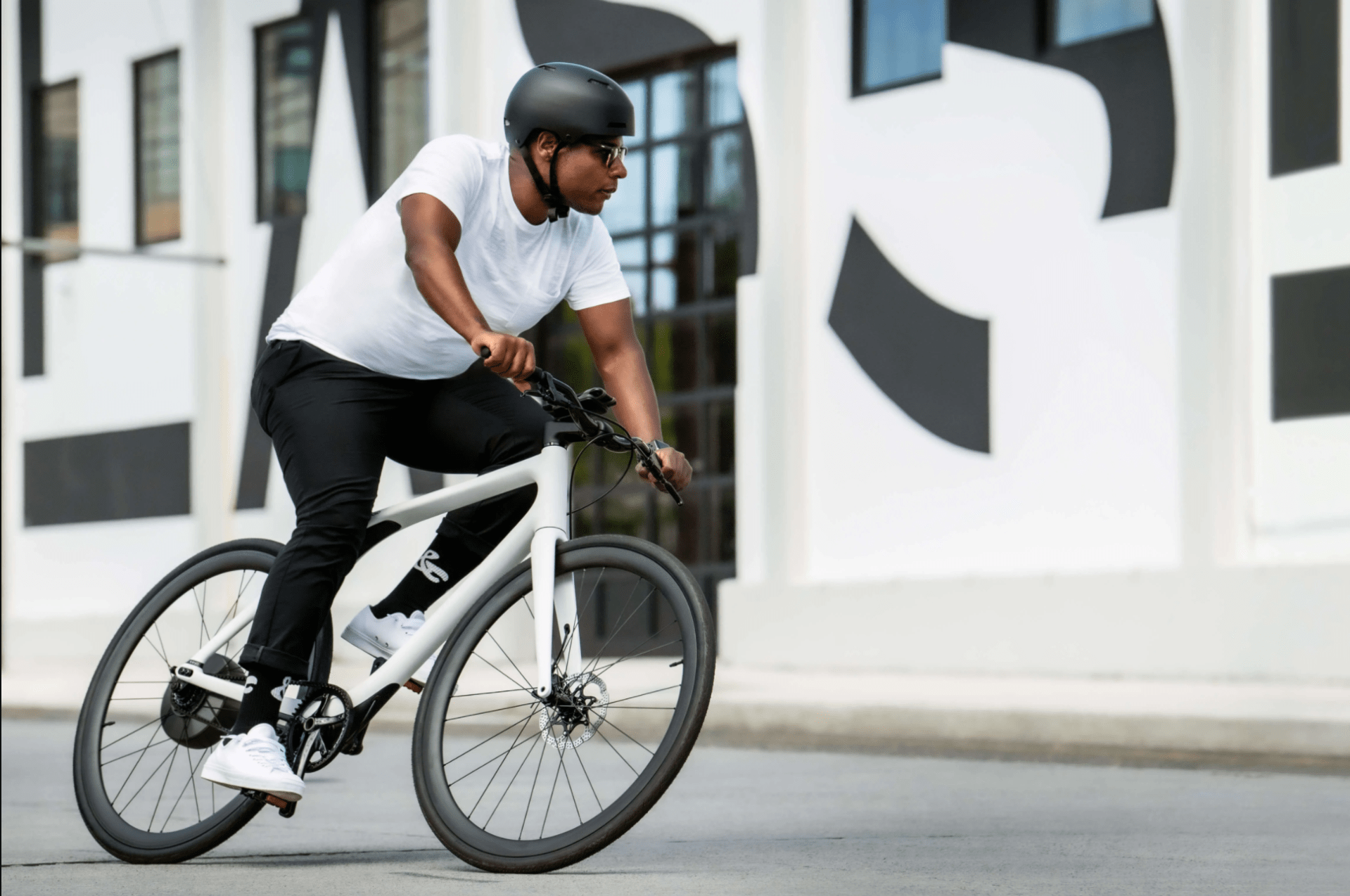 a man riding a white bike