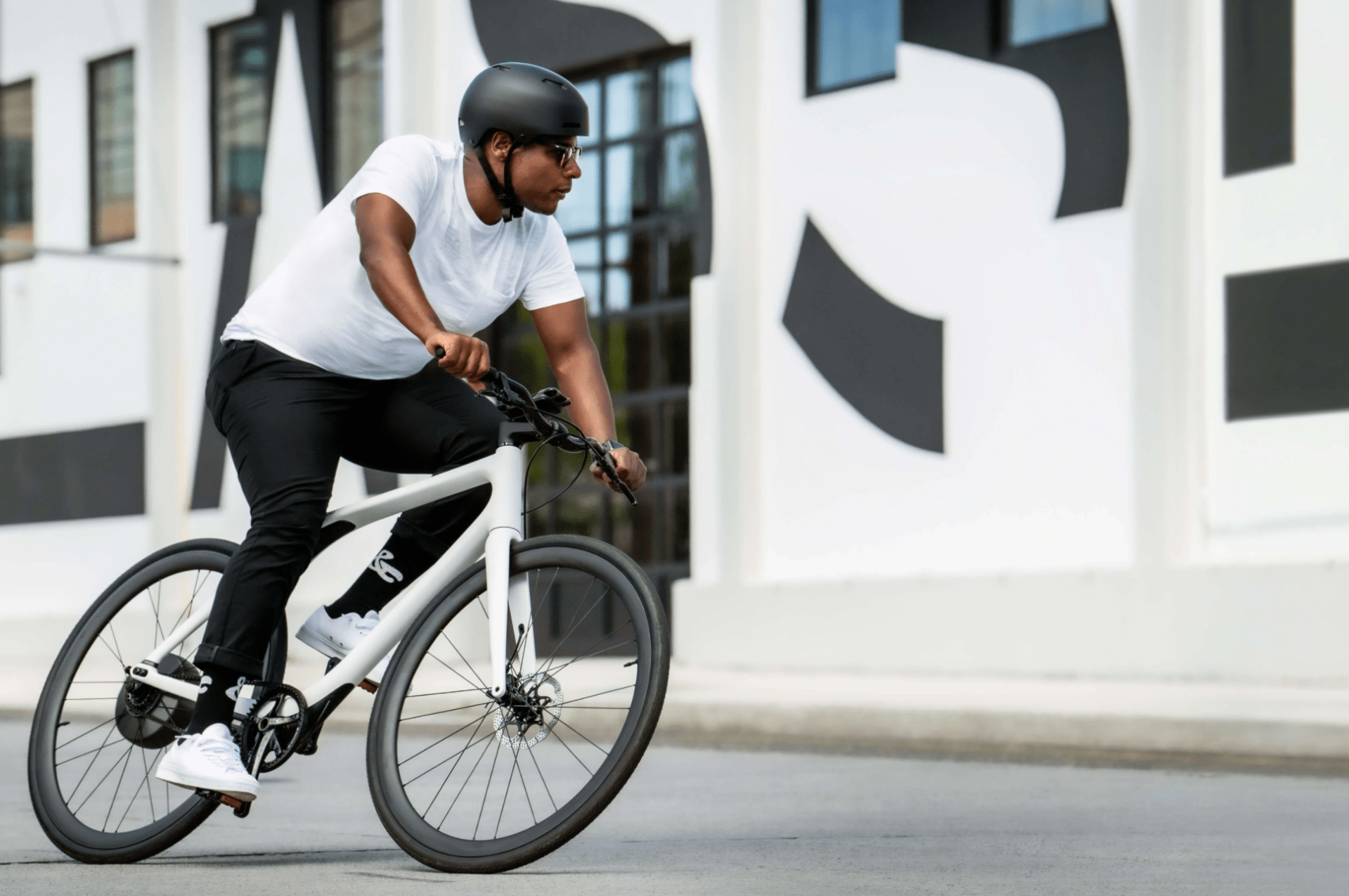 a man riding a white bike