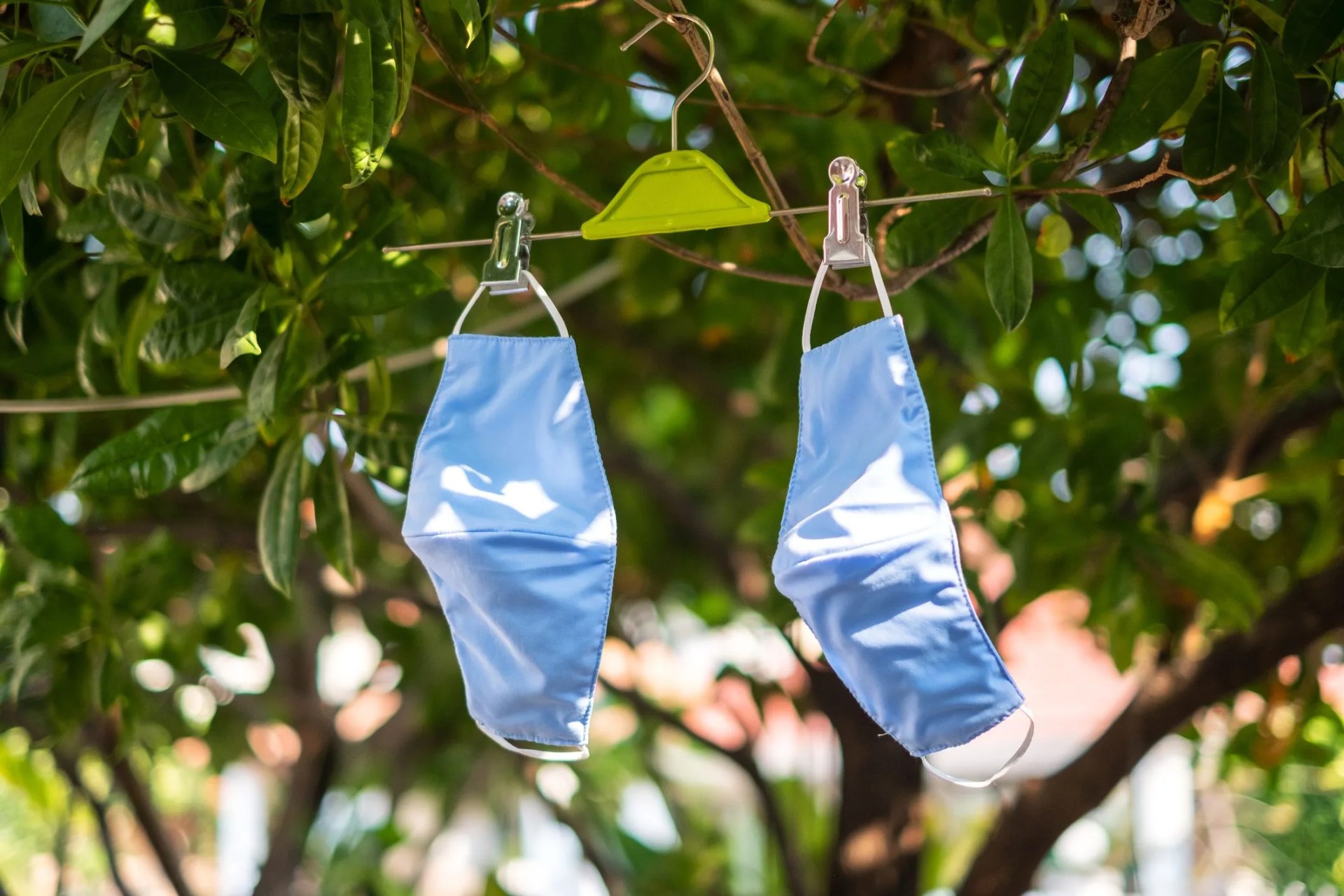 hanging and drying fabric face masks in the sun