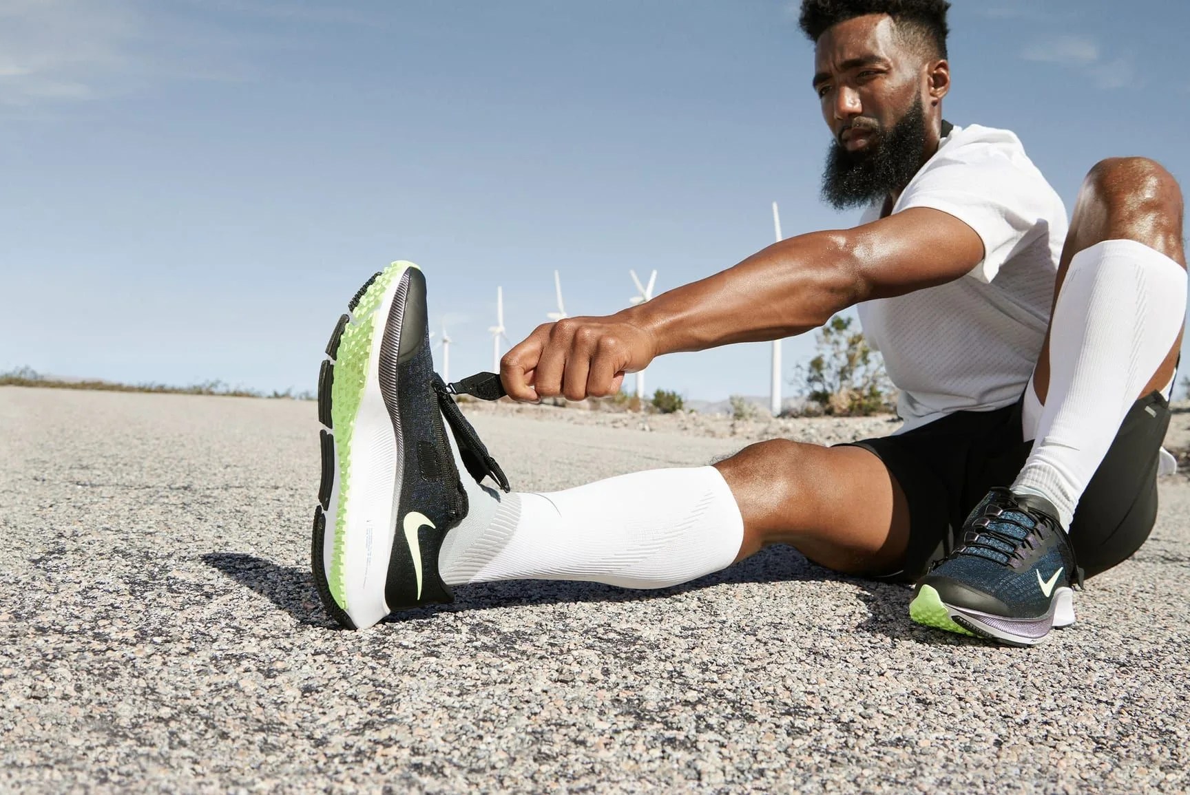 man putting on nike air zoom pegasus 37 fly ease running shoes