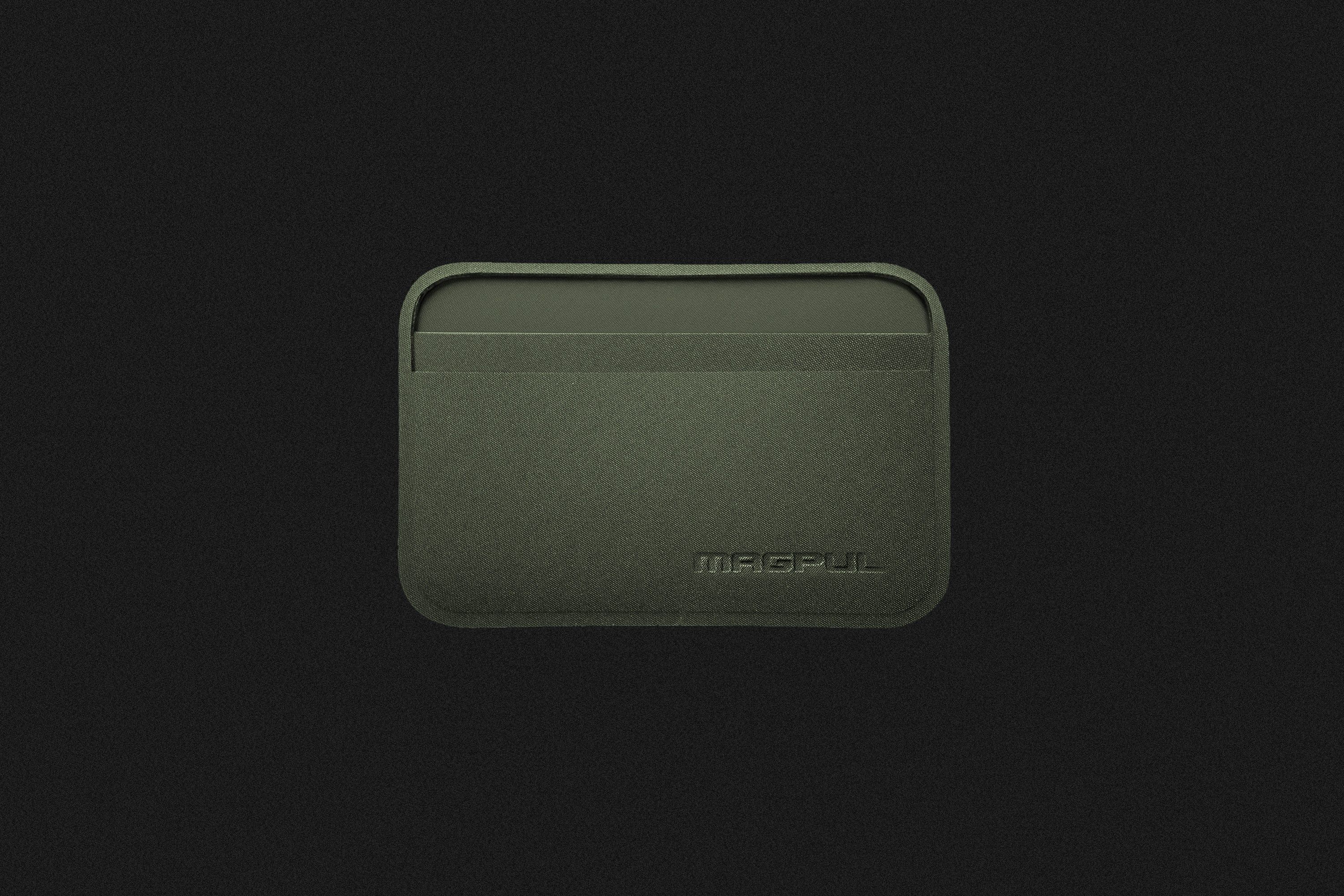 a thin green wallet on a black background