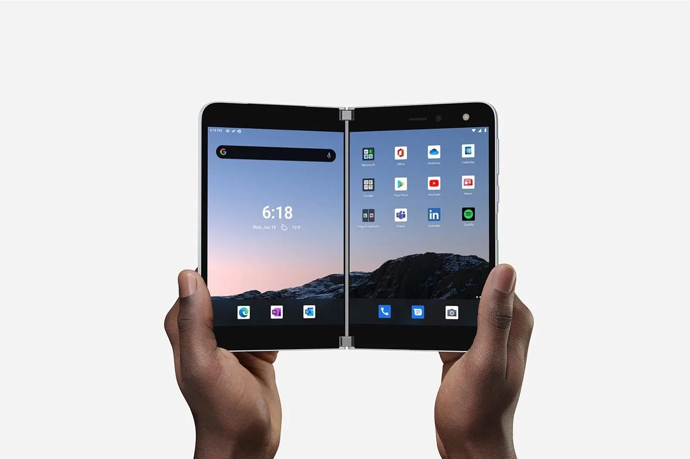 two hands holding microsoft's folding surface duo phone open like a book