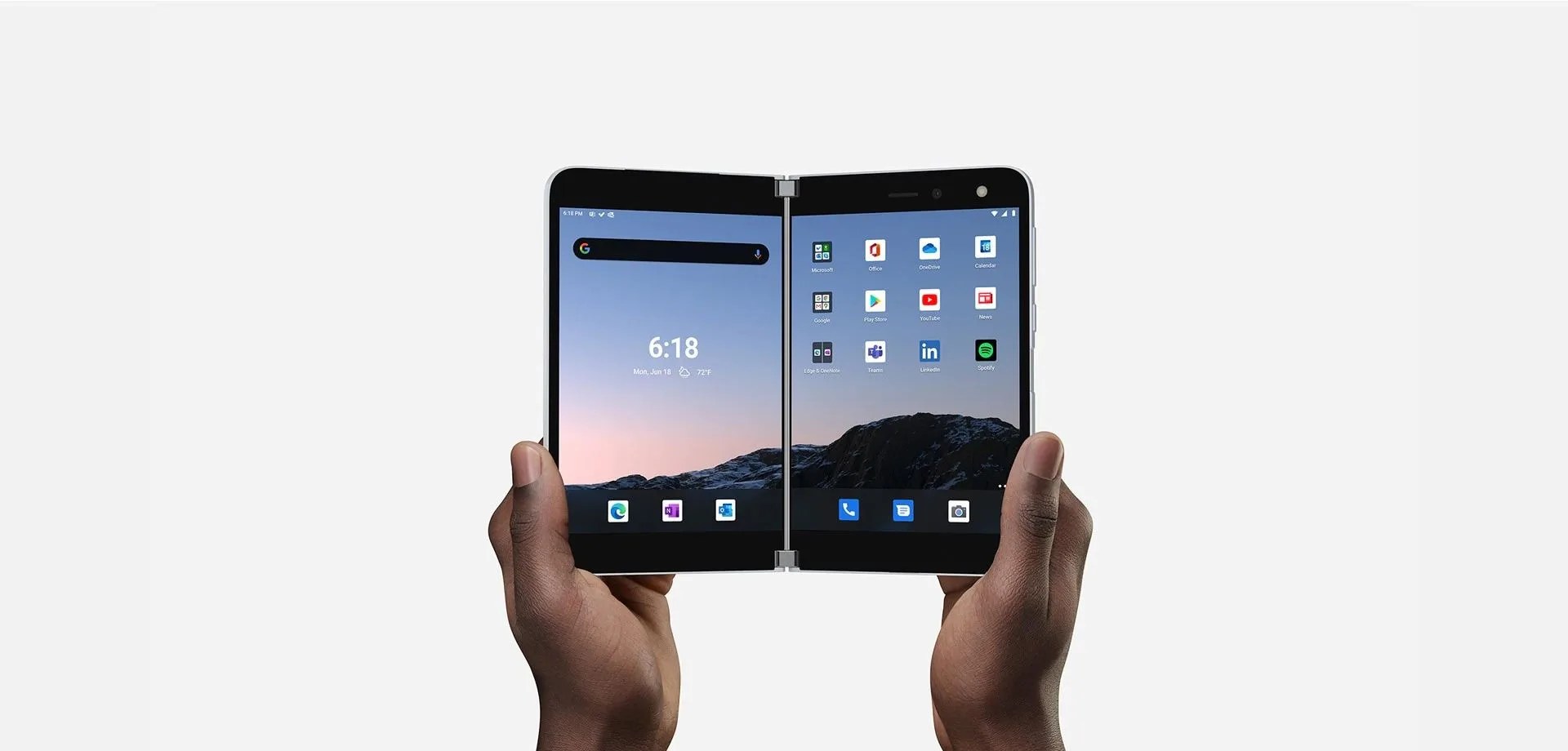 two hands holding microsoft's folding surface duo phone open like a book