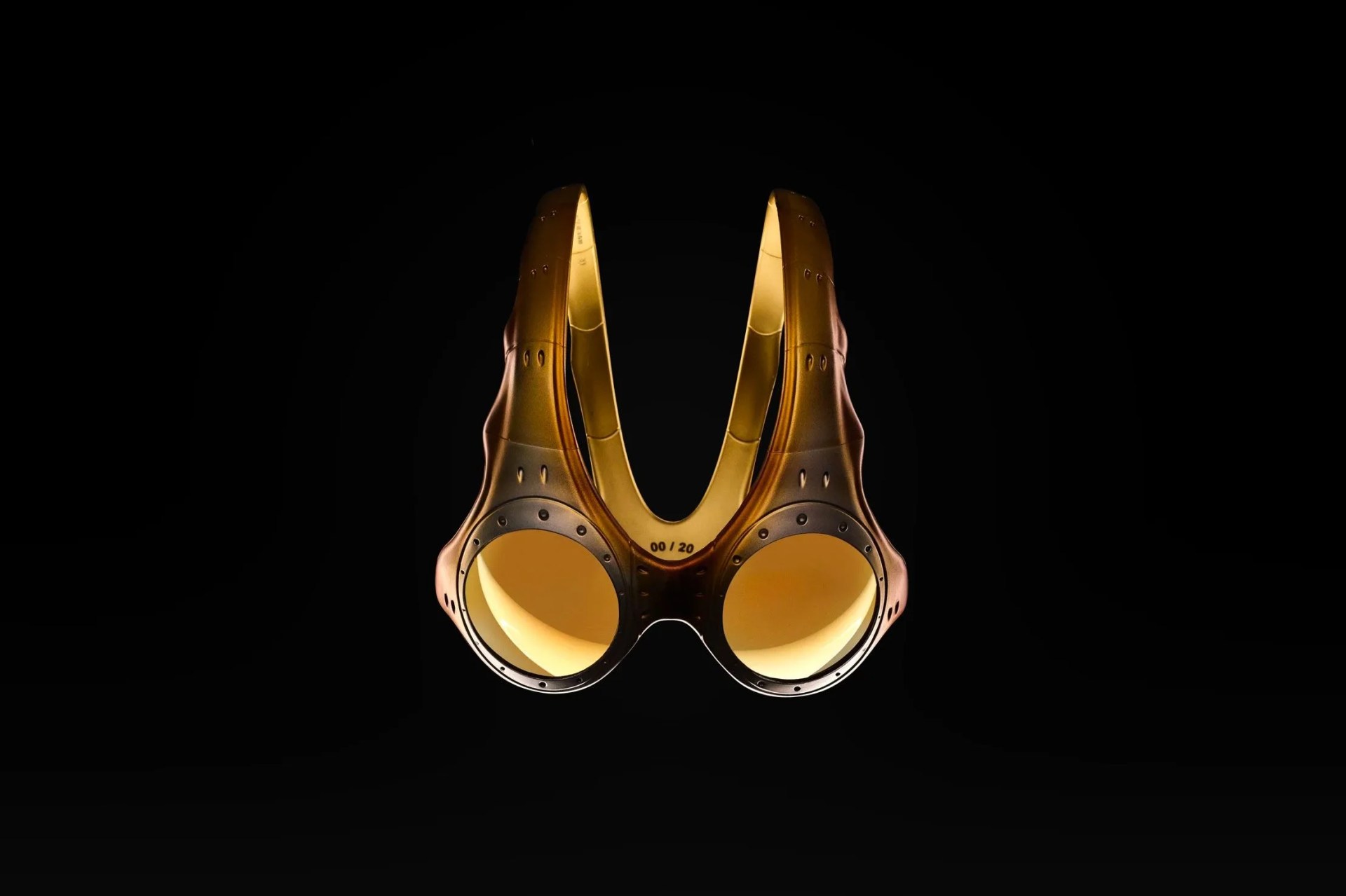 a pair of gold sunglasses with a frame that goes over the top of the head
