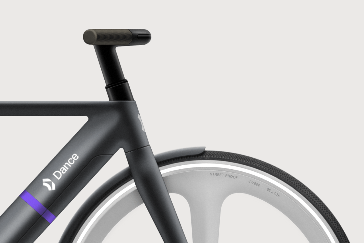 a close up of a black bike's handlebars and wheel