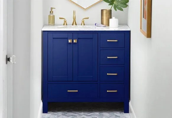 blue bathroom vanity with gold hardware and marble top