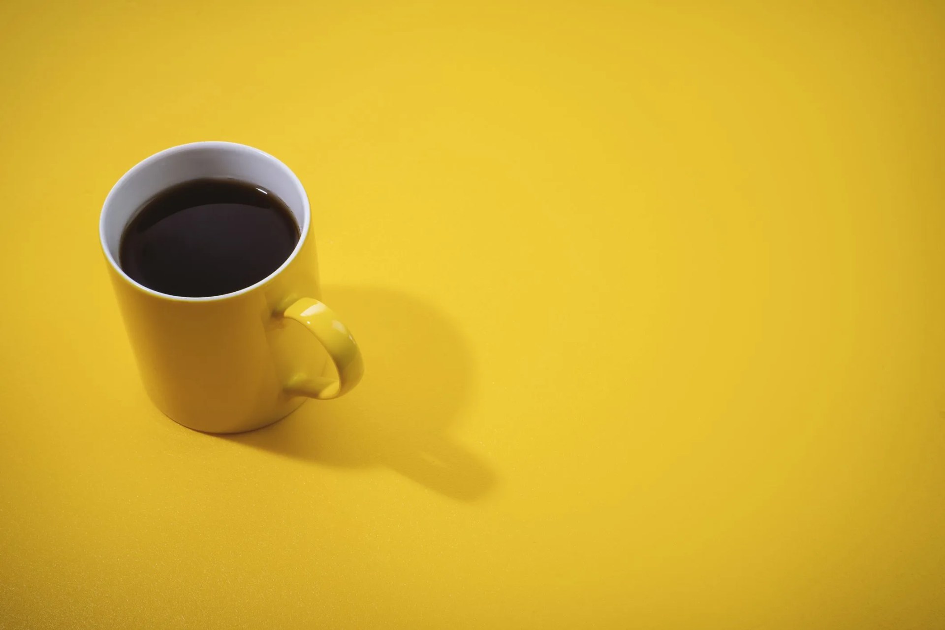yellow coffee mug on yellow background