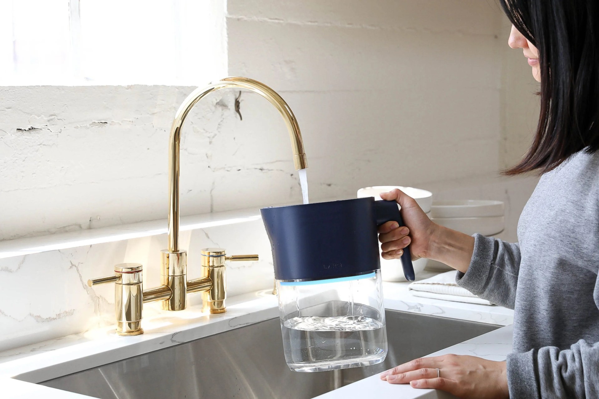 larq water pitcher being filled