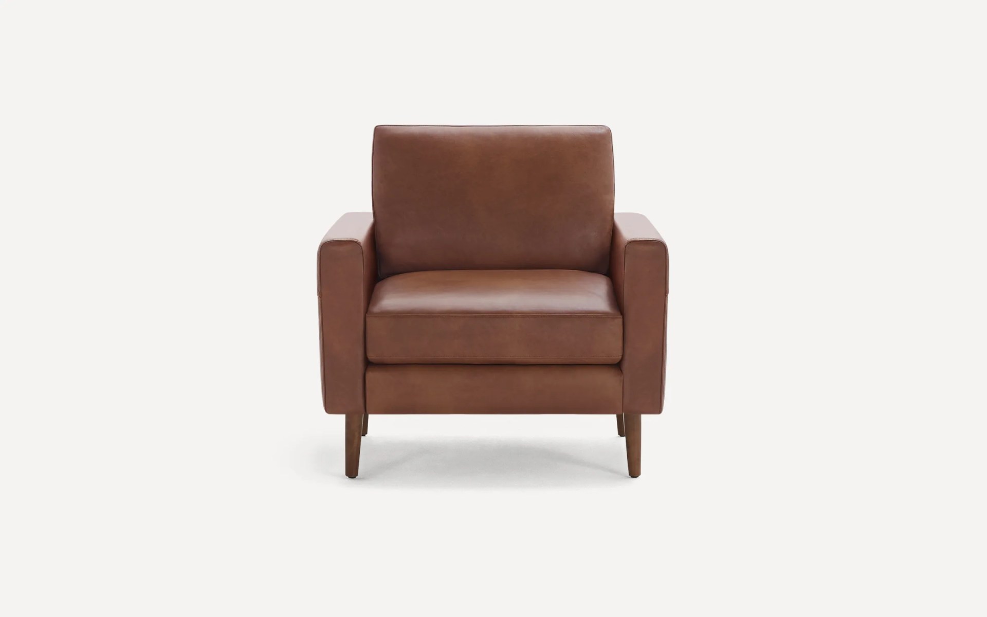 a brown leather chair on a white background