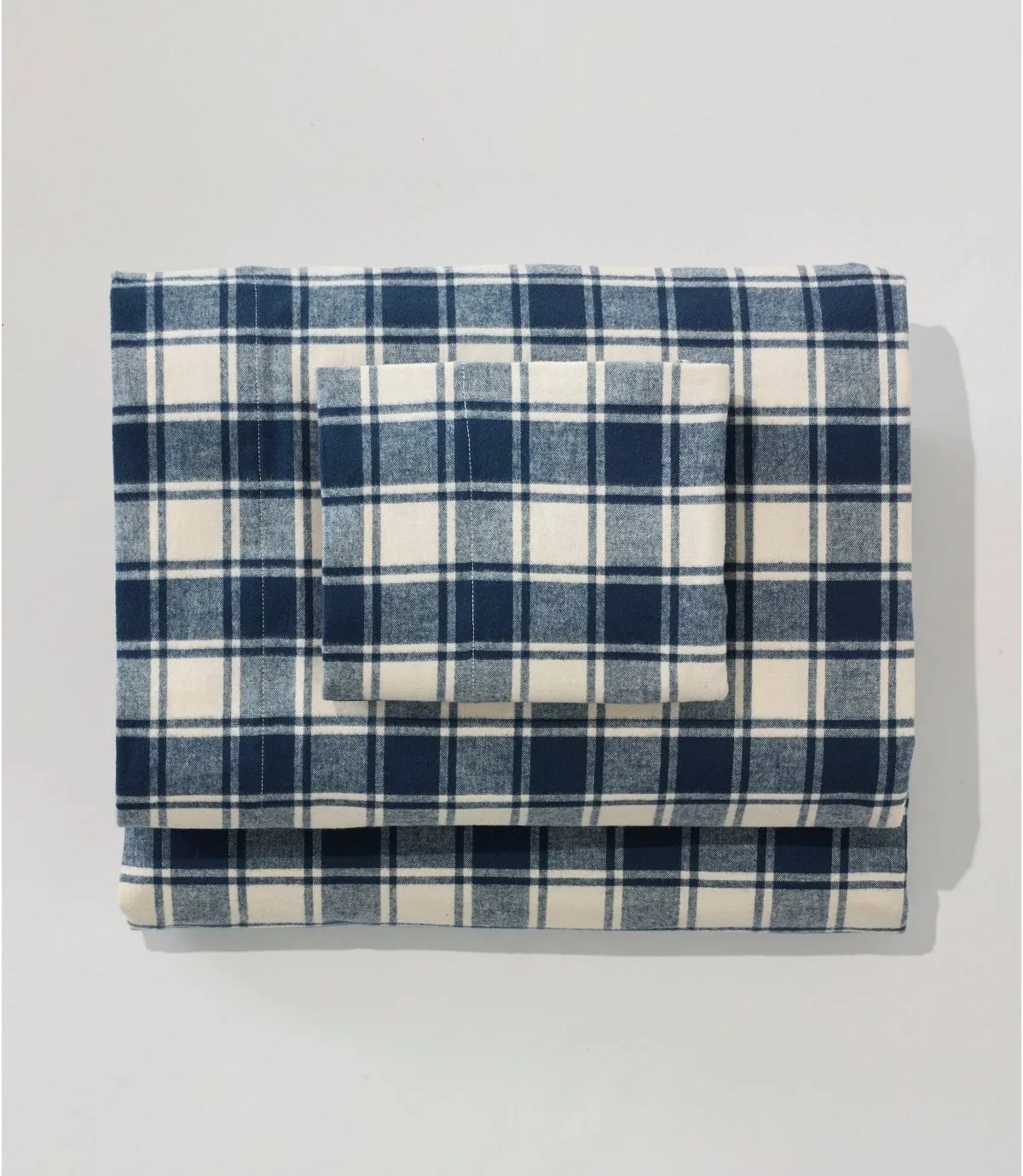 A blue checkered flannel sheet set on a gray background.