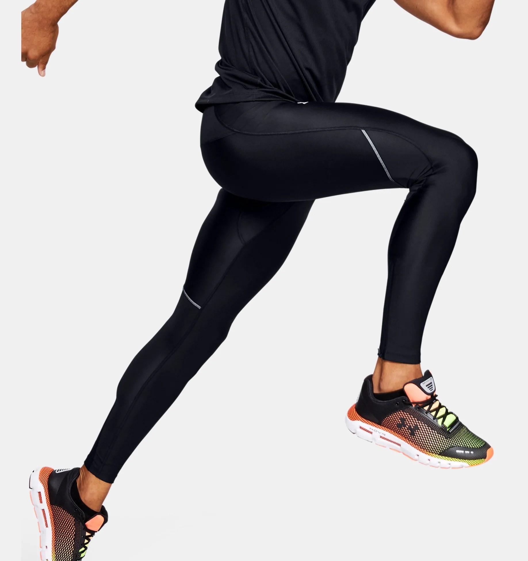 A model wearing black tights and sneakers