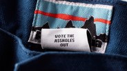 a patagonia tag with the phrase "vote the assholes out"