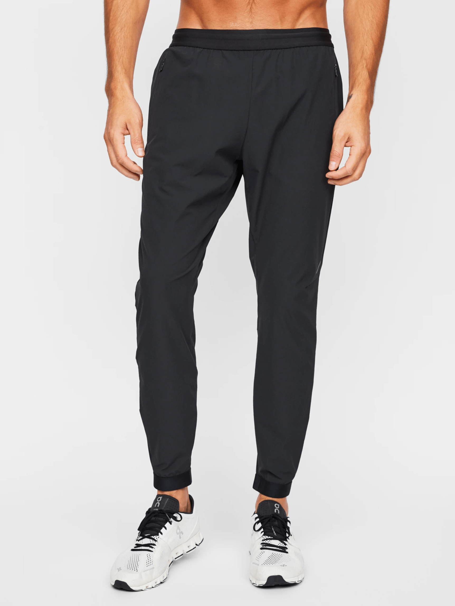 A model wearing black run pants