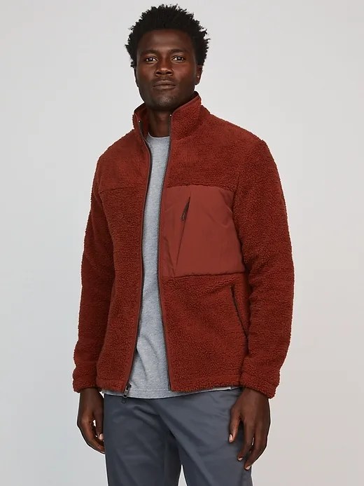 A model wearing a red fleece jacket