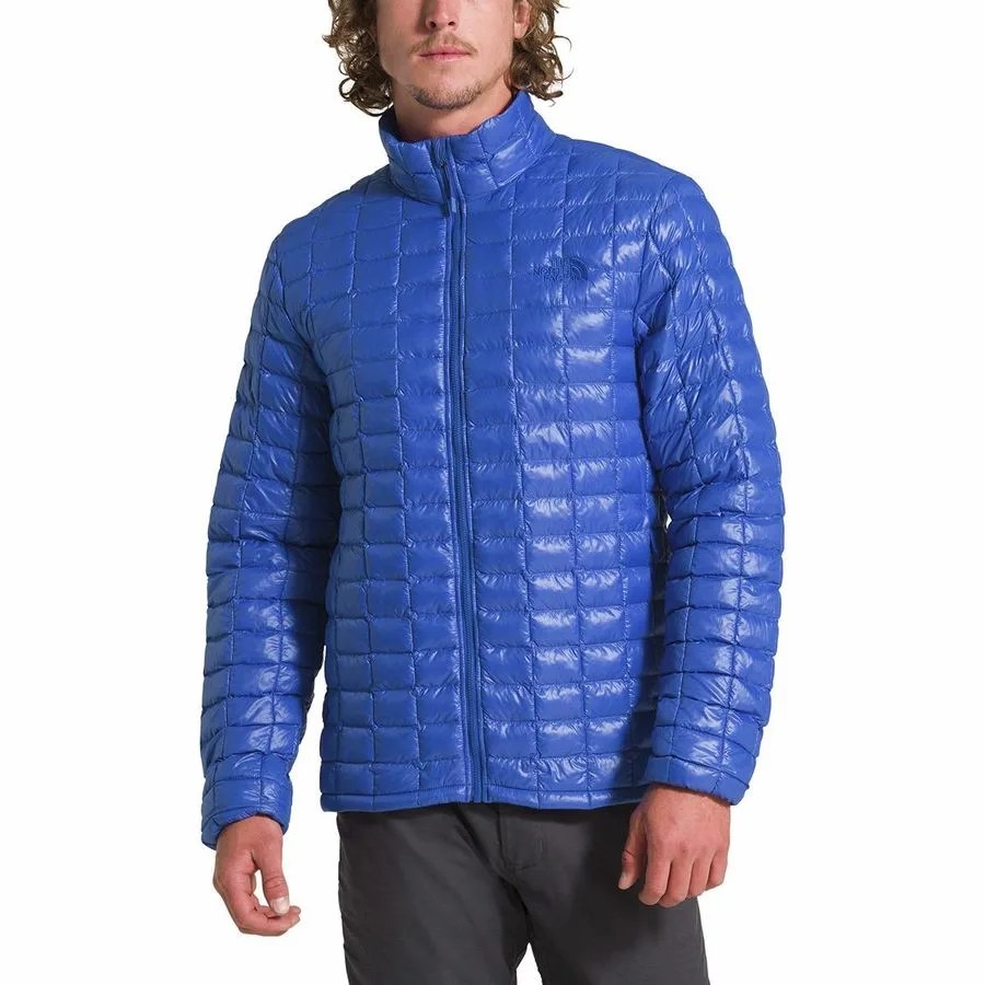 A model wearing a blue insulated jacket