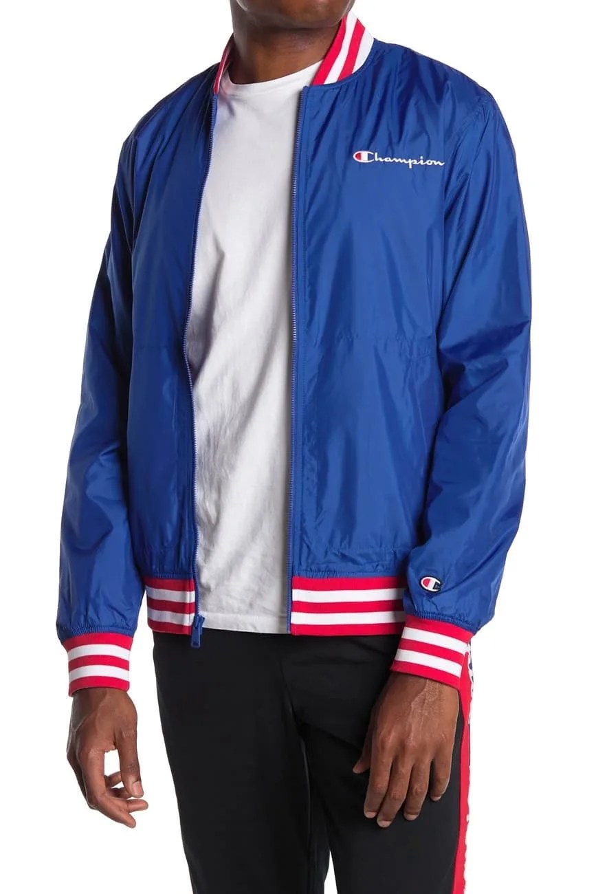 A model wearing a baseball jacket