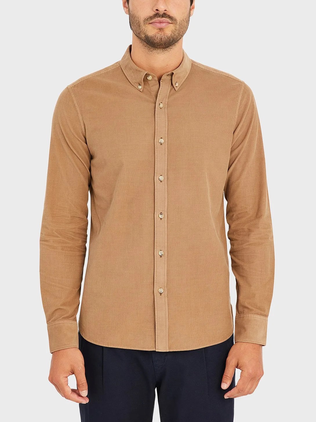 A model wearing a tan corduroy shirt