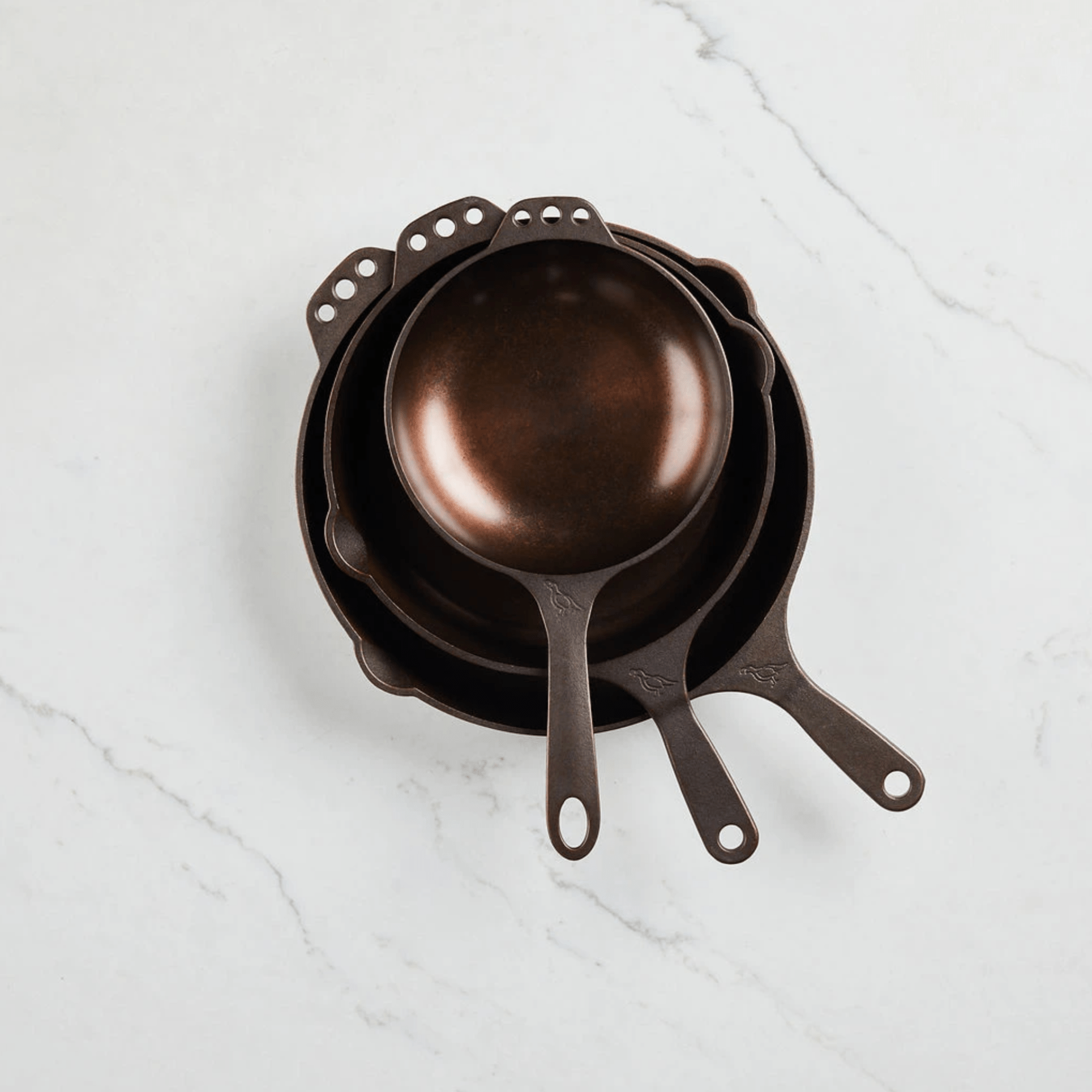 A set of three cast-iron skillets