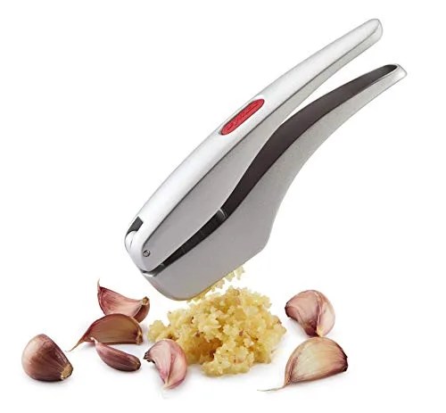 garlic press next to garlic cloves