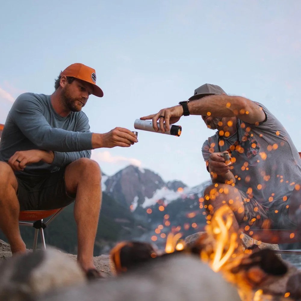 two models in front of a campfire