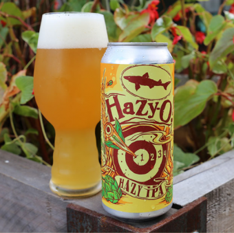 a hazy ipa beer can poured out into a glass