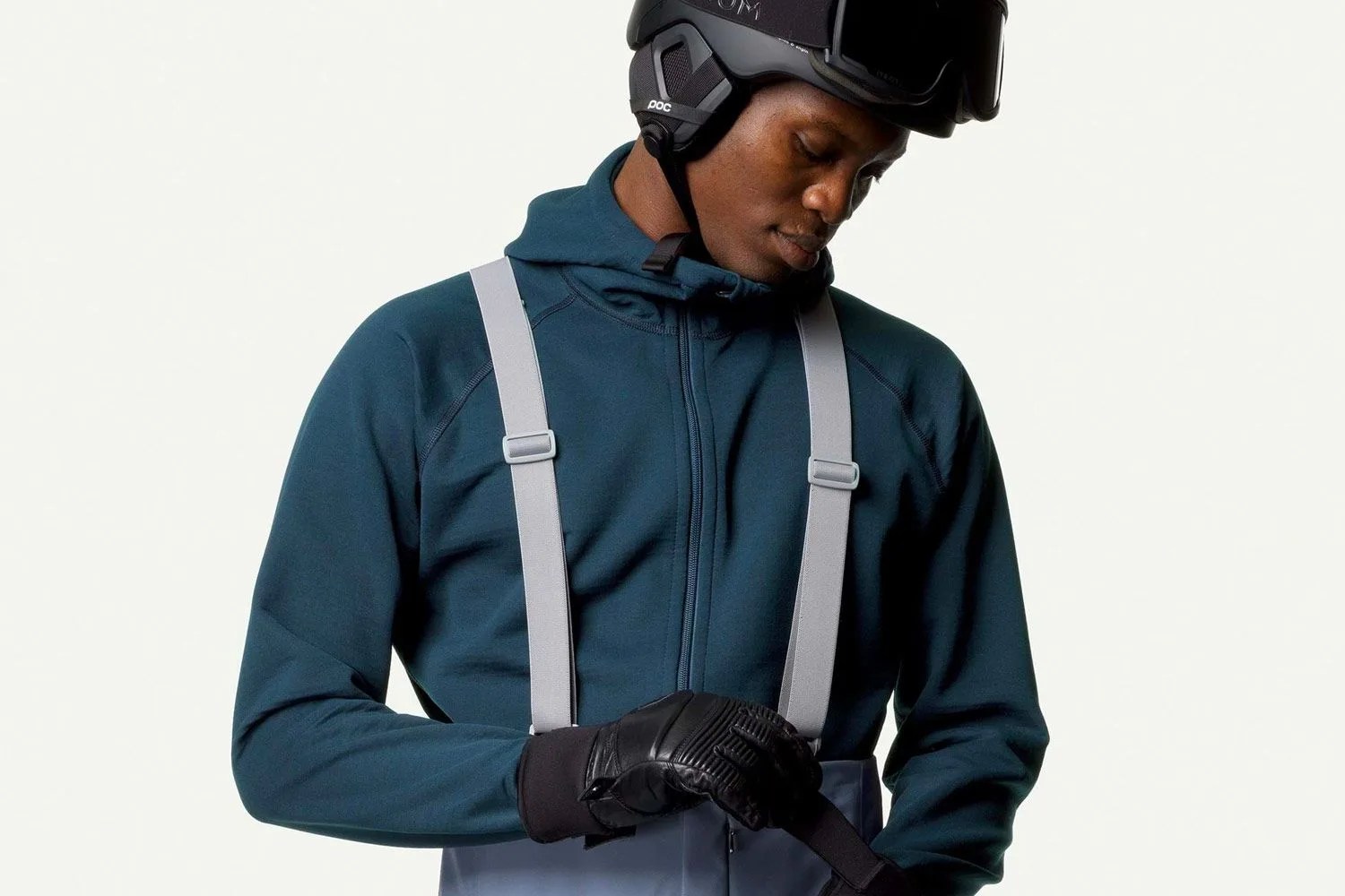 a man wearing a blue fleece and a ski helmet