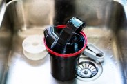 film developing tank with 135 photographic film in a tank after developed close up