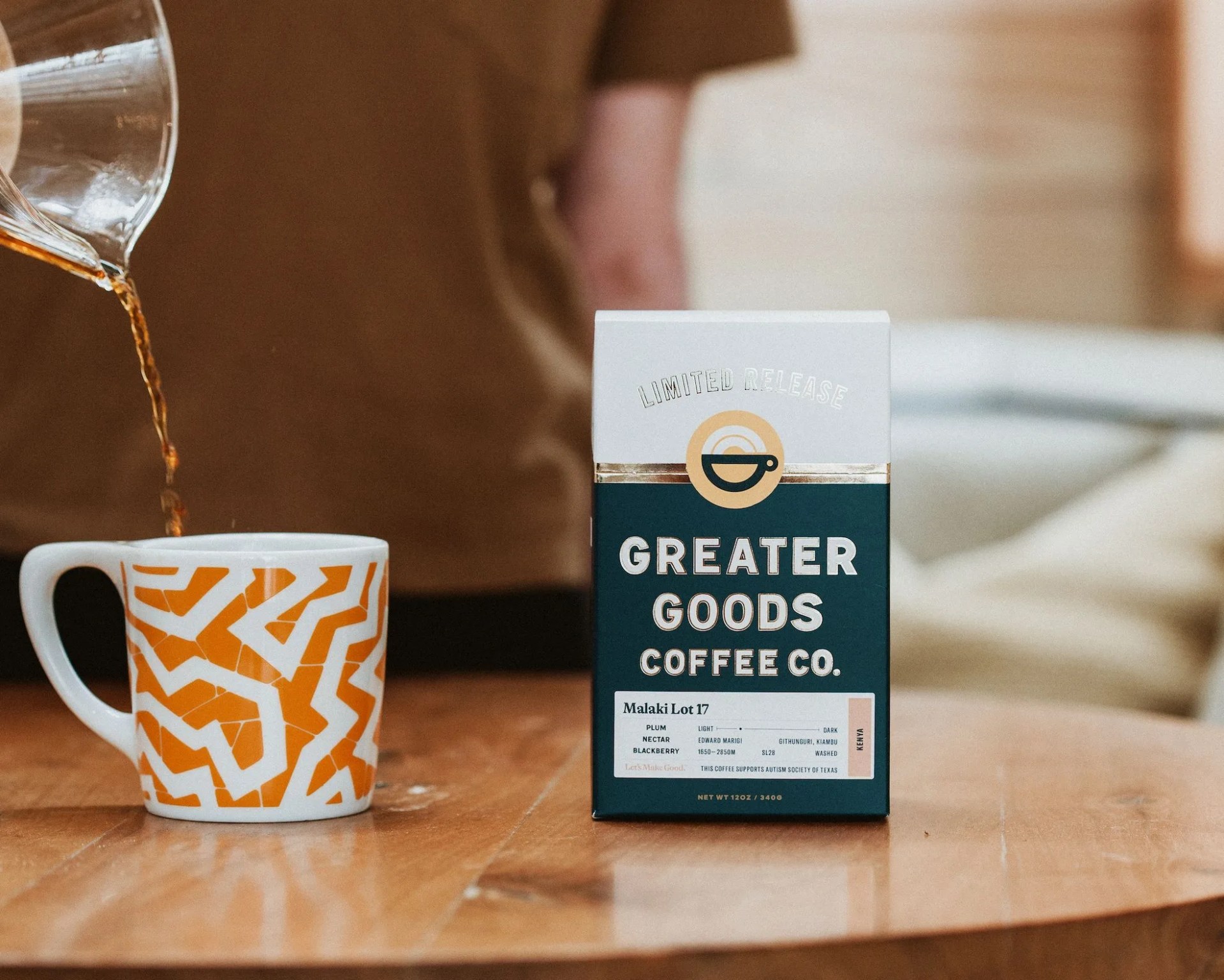 pouring coffee into mug next to bag of coffee