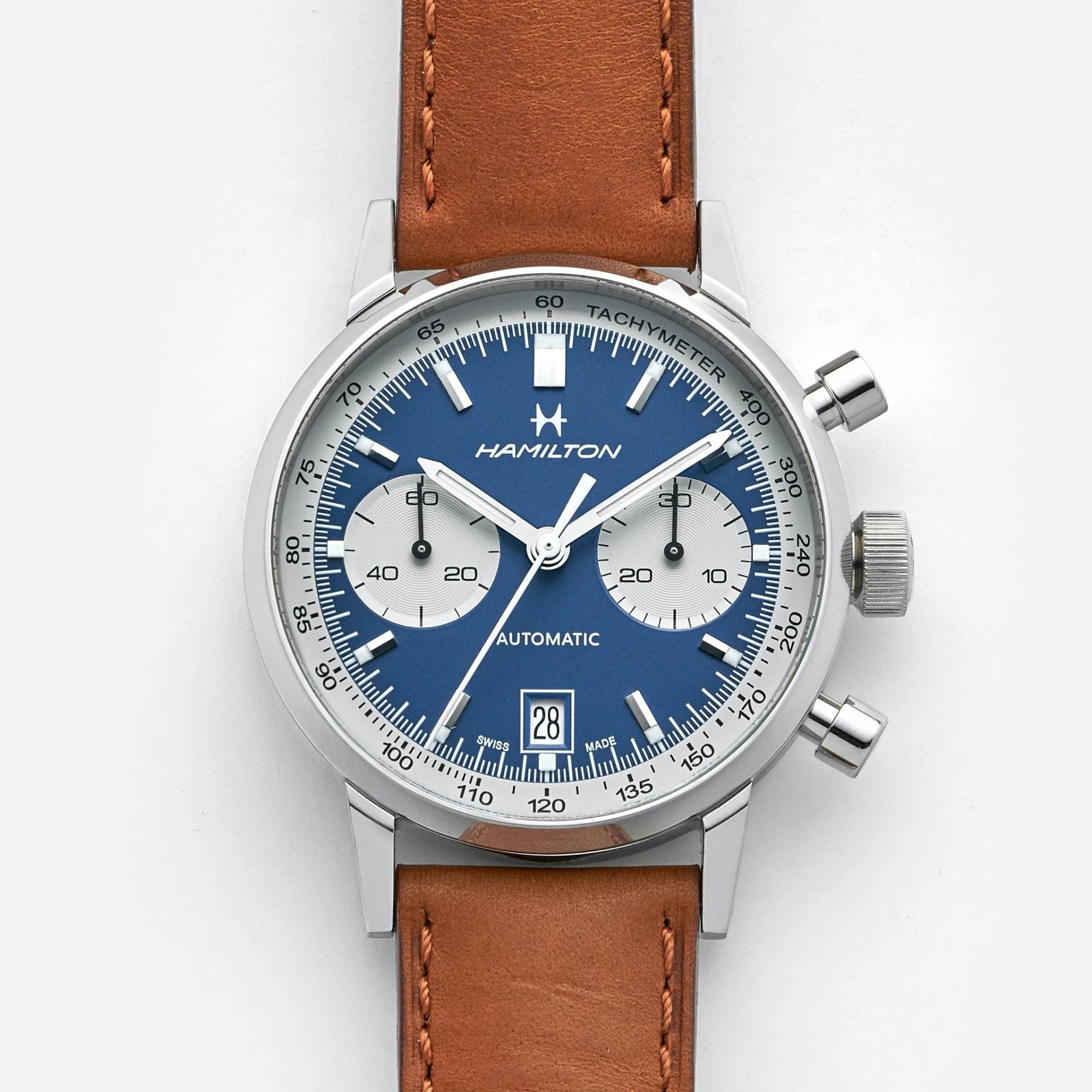 blue chronograph watch on tan leather strap