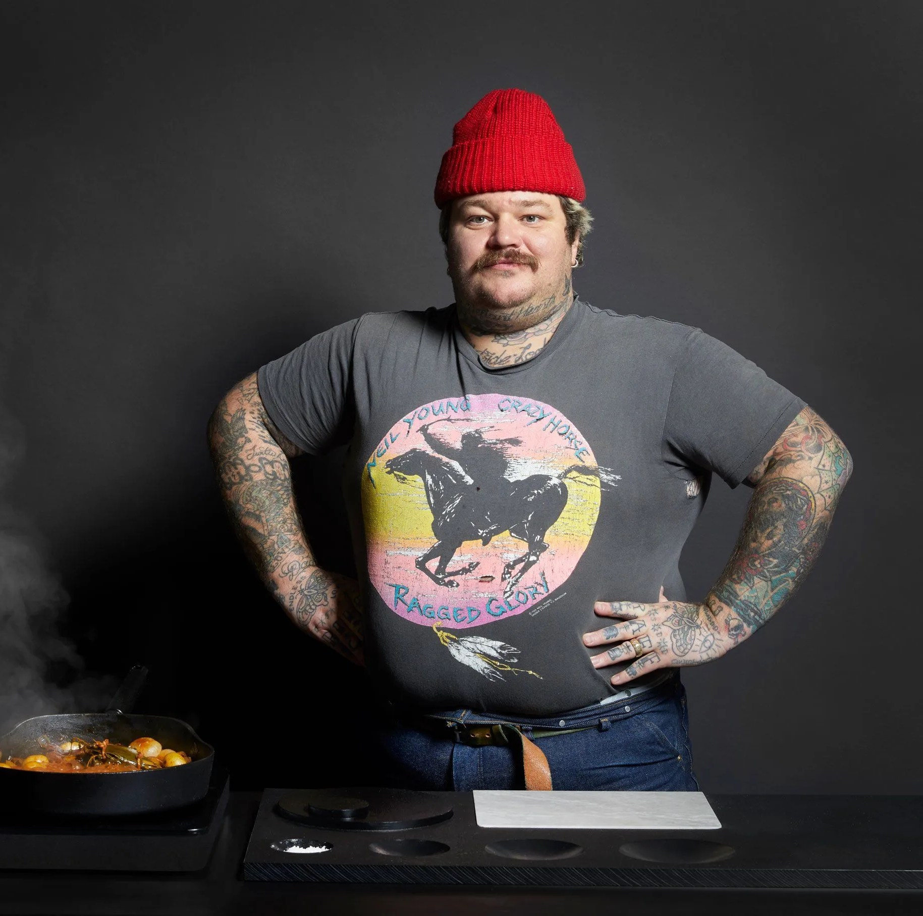 man standing next to steaming pan