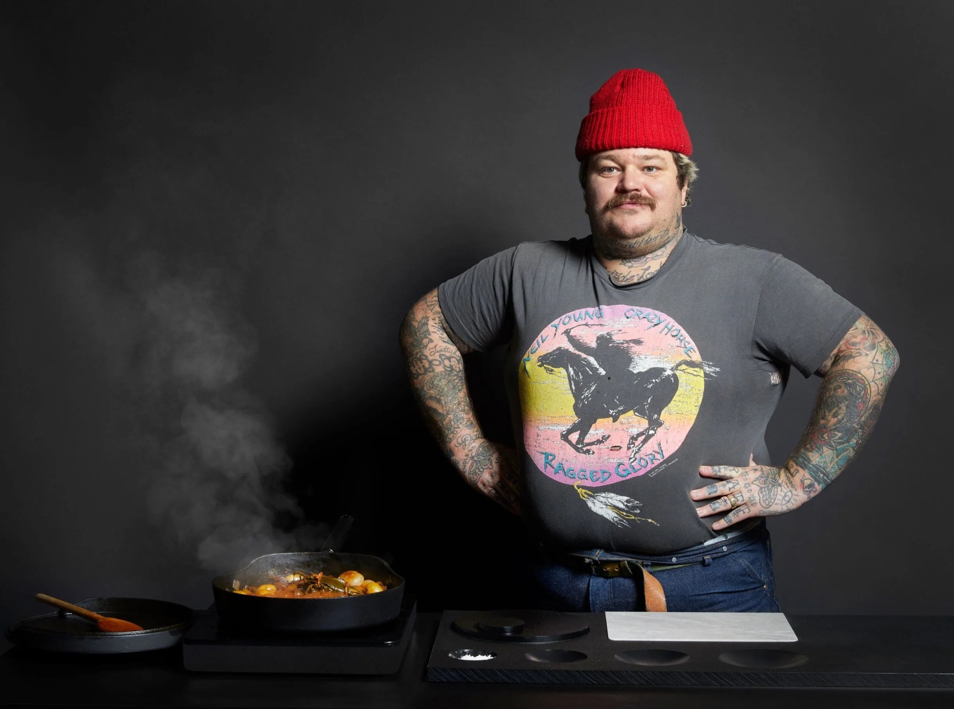 man standing next to steaming pan