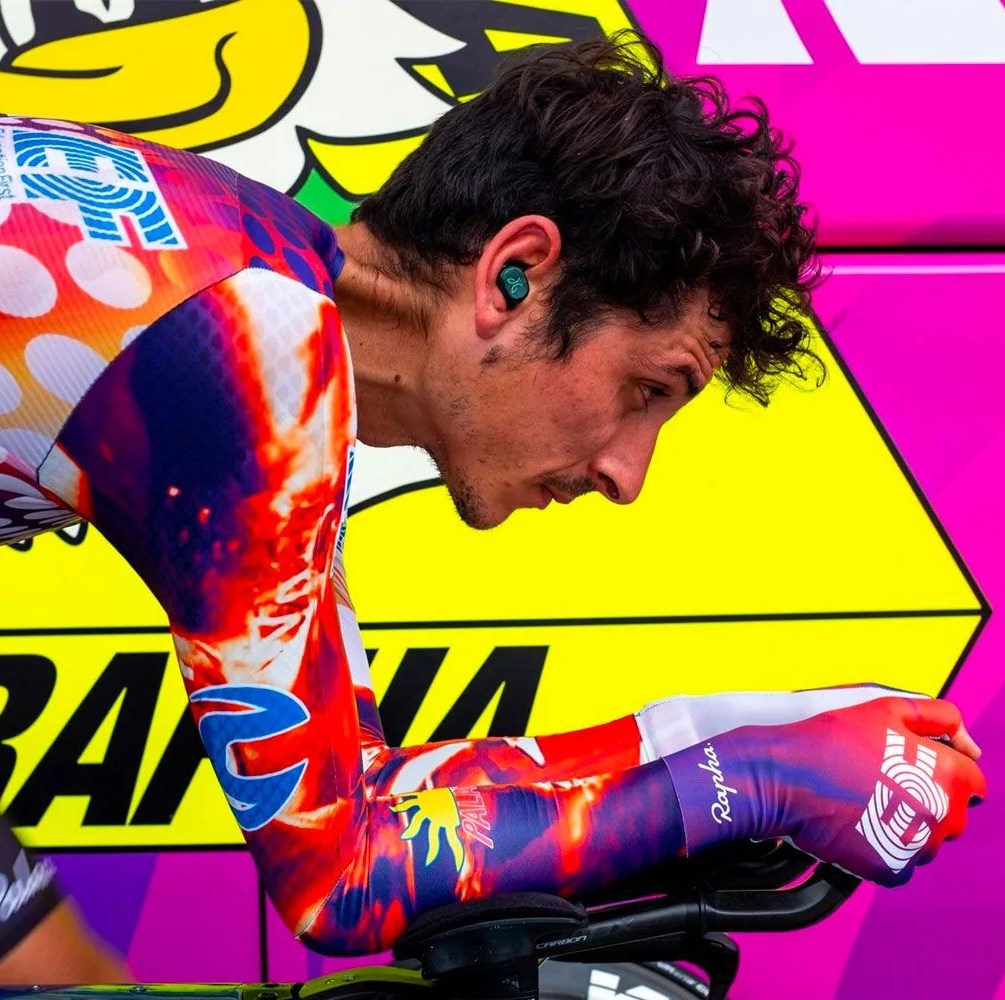 a man riding a bike wearing a colorful outfit