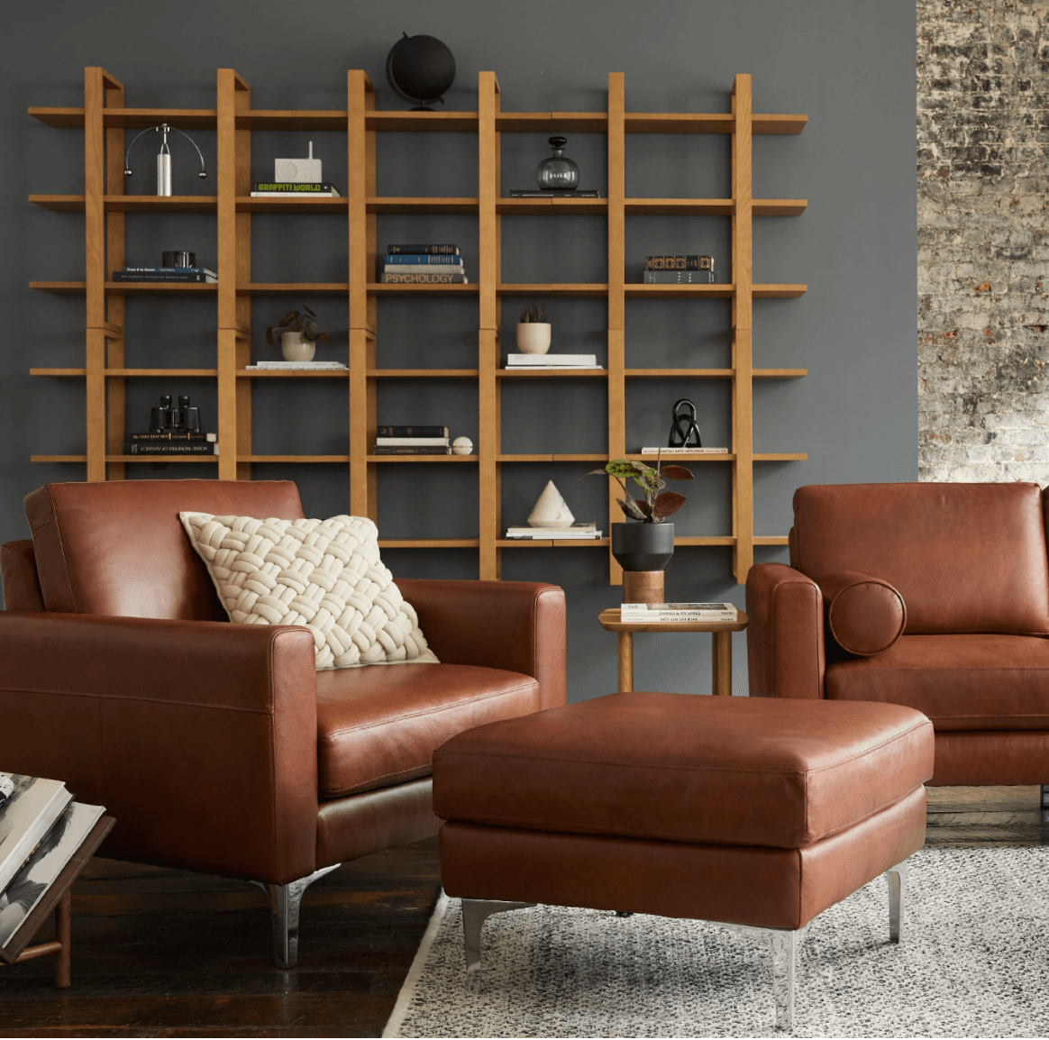 living room with open shelving and leather chair