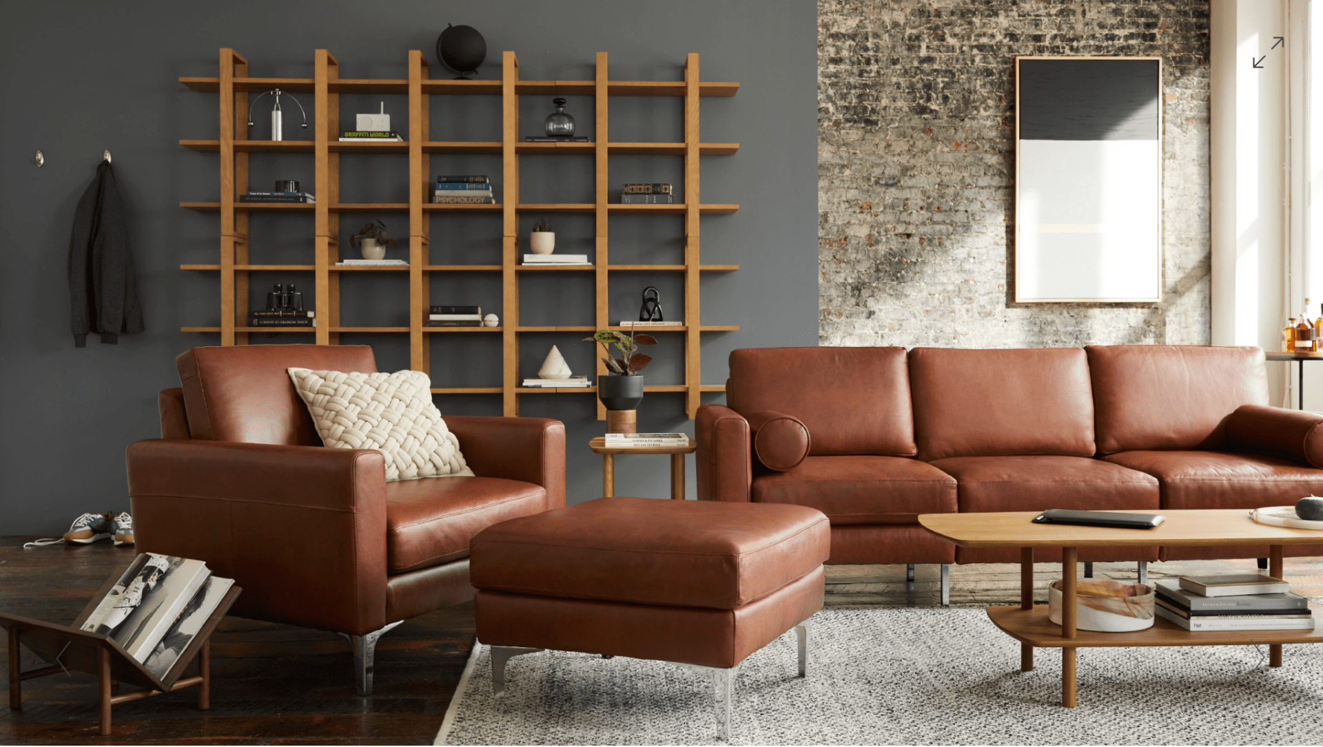living room with open shelving and leather chair