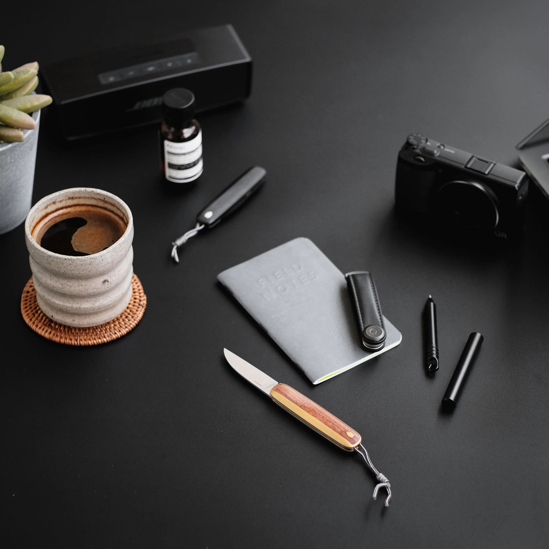 a pocket knife on a table with other items