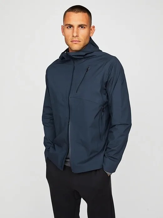 a man wearing a navy rain jacket